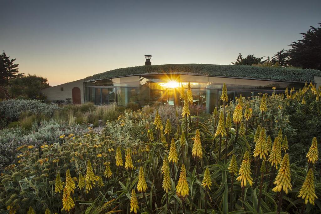 This 100+ acre nature preserve with white sand beach, redwood forest, and 360 degree views is where Big Sur architect Mickey Muennig chose to design his final residential masterpiece. Set within Deer Ridge by way of a sod roof that also provides insulation, Muennig created this luxurious off grid residence on a site with views all the way to San Luis Obispo and Santa Cruz counties. Radiant heat warms the huge concrete foundation which supports the massive north and south facing glass walls that bring the outside in. Exquisite wood craftmanship defines the 3 bdrms and 3 baths in the main house and the detached guest house which provide the base from which to explore the property's micro-climates, habitats, seasonal streams, miles of trails, and white sand beach that may only be reached from this property, or the sea. Just above the un-named beach, a potential building site sits within a natural amphitheater of land which just may be the most private oceanfront site on the entire coast.