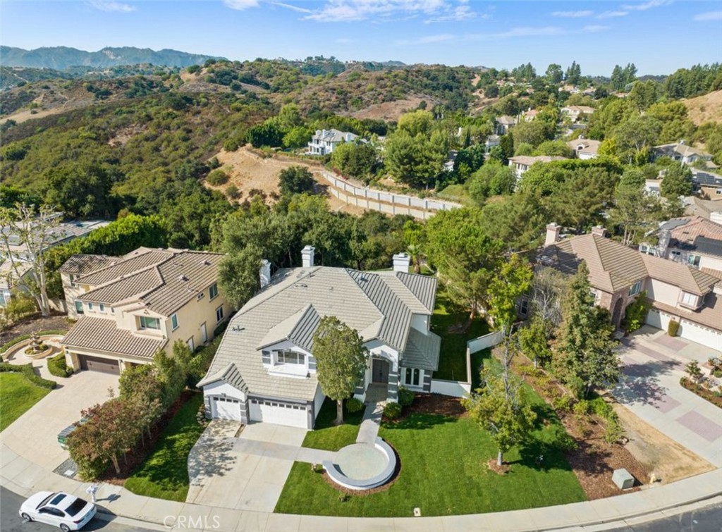 SHORT SALE is subject to lender approval. INCREDIBLE OPPORTUNITY! Perched at the top of Topanga Canyon in the exclusive guard-gated Summit Pointe Estates at the end of a flat cul-de-sac this stunning renovation completed in 2025 is a 5 bed + office 5 bath spanning 4150SF with 3-car garage is a showpiece of light, luxury and lifestyle. Soaring ceilings and a dramatic double-height foyer welcome you inside to a sun-drenched living room and formal dining room. Wide plank wood floors throughout. A chef’s dream kitchen with sleek stainless appliances, Quartz waterfall countertops, breakfast bar, and seamless flow open to the inviting family room with fireplace. Main level has a home office or billiard room plus a guest suite or maids room, powder room and laundry room add convenience. Upstairs; a loft-style lounge leads to 4 bedrooms, 1 en-suite, 2 with Jack & Jill bath and a spectacular primary suite with vaulted ceilings, dual walk-in closets and spa-inspired bath overlooking mountainous views. Outdoors, the expansive private backyard affords plenty of room for an infinity pool, spa, fire pit and fabulous outdoor living and entertaining and tranquil canyon views that create this ultimate private oasis. PLUS, a rare huge side yard that provides room for a pickleball court and more. The front sweeping wide lot offers room to add an additional driveway. Truly an entertainer’s paradise or serene escape in one of Topanga’s most coveted communities adjacent to Woodland Hills with the BEST blend of access to both the beaches of Malibu and the San Fernando Valley. Close proximity to Viewpoint School. New roof, new HVAC, windows, electrical, plumbing, lighting, doors, hardware, paint & more! Be the first to occupy this beautifully renovated home!