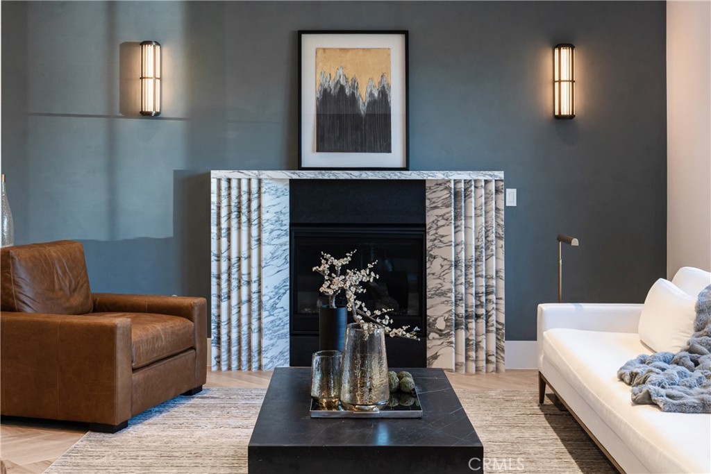Welcome to your not-so-typical modern farmhouse, nestled in the charming neighborhood of Toluca Woods. This stunning new construction property embodies luxury and sophistication across its expansive 4,000 sqft, seamlessly combining modern design with wellness-centric features that cater to your every need. Step inside to an expansive foyer that leads into a light-filled open-concept living space, designed for both comfort and elegance. The gourmet kitchen is a culinary dream, featuring top-of-the-line appliances from renowned brands like Wolf, Cove, and Sub-Zero, along with custom cabinetry and a large island with a bar top, perfect for casual meals or entertaining. This magnificent home features four generously sized bedrooms, each with its own luxurious en-suite bath. The bathrooms are designed with high-end fixtures and spacious walk-in showers. Upon entering the primary suite, you’ll be greeted by a cozy fireplace that sets the mood for relaxation. A corner bar adds a touch of indulgence, while double doors lead to an exclusive balcony, overlooking the backyard and a perfect spot for morning coffee. The en-suite bathroom, features a soaking tub, offers a true spa-like experience. The boutique-like walk-in closets feature custom shelving and ample space for even the most extensive wardrobe. This home prioritizes your well-being with the Ketra Circadian Lighting system, syncing with your body’s natural rhythms for better sleep and health.The Crestron smart home system offers seamless control, while live plant walls bring nature indoors, creating a calming ambiance. The Delos Wellness System further enhances air quality, lighting, and overall wellness, ensuring every aspect of the home supports a healthier lifestyle. For entertainment enthusiasts, the home offers a high-end, fully equipped home theater. The property includes a spacious two-car garage, providing convenience and security. The beautifully landscaped yard welcomes you to an outdoor oasis, with a resort-style lap pool and a charming pool cabana—perfect for lounging in the sun or enjoying a refreshing drink. The outdoor BBQ area is ideal for entertaining, featuring modern grilling appliances. An additional bathroom and shower by the pool ensure convenience for all guests. Located just minutes away from Toluca Lake Village, Burbank Village, Trader Joe’s, fitness hubs like Equinox and SoulCycle, Warner Bros. Studios, and Universal Studios. 5131 Strohm Ave is not just a house; it’s a lifestyle.