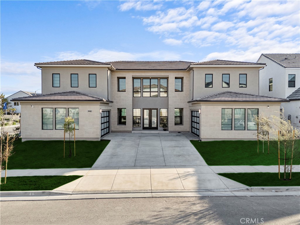 Welcome to this breathtaking estate at 24152 West Corte Ala, nestled within the exclusive gates of the prestigious Tesoro Highlands community in Valencia, which showcases over 5,000 square feet of masterfully designed living space—an architectural triumph where classic sophistication meets modern luxury. As you arrive, you’re welcomed by dual two-car garages flanking a grand central entrance, where a stunning double staircase frames the soaring two-story foyer. This dramatic entry sets the tone for a home defined by elegance, volume, and natural light. The interior design seamlessly blends timeless craftsmanship with contemporary flow, creating a space that is both functional and awe-inspiring. The heart of the home is a luxury chef’s kitchen, complete with an expansive center island and breakfast bar, walk-in pantry, custom cabinetry, and a pass-through to the formal dining room. It opens effortlessly into a spectacular two-story great room, perfect for entertaining or enjoying quiet moments with panoramic mountain views just beyond your windows. Step outside to your private outdoor living space—ideal for alfresco dining, relaxing evenings, and soaking in the golden California sunsets. The primary suite is a true sanctuary, featuring dual vanities, a soaking tub, oversized walk-in shower with bench seating, and a spacious walk-in closet designed to impress. Upstairs, you’ll find three generously sized bedrooms, a second family/bonus room, and views that capture the serenity of the surrounding hills. On the main floor, two additional bedrooms offer versatility for a home office, gym, or guest quarters. Set on a 10,333 sq ft lot, this property delivers both grandeur and comfort in one of Santa Clarita's most sought-after communities. Residents enjoy access to resort-style amenities, including a luxurious clubhouse, pool and spa, tennis courts, BBQ area, and scenic picnic spots—all within a tranquil, guard-gated enclave. With its flawless floor plan, majestic mountain views, and seamless indoor-outdoor living, this home offers the ultimate Southern California lifestyle—ideal for the discerning buyer seeking space, privacy, and prestige.