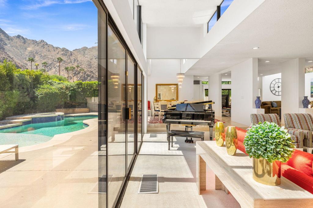 Welcome to your serene oasis at 46220 Manitou Drive, Indian Wells, CA. This stunning custom home boasts 3,851 square feet of open, contemporary living space. Immerse yourself in the natural light that floods through high ceilings, illuminating the open floor plan. Enjoy breathtaking mountain views from every angle of this thoughtfully designed home. A rare find in Manitou Springs, it features the lowest price per square foot in Indian Wells Country Club. The expansive 10,018 square foot lot provides ample outdoor space for relaxation in the pool and spa with majestic mountain views. With a low HOA, you can focus on enjoying the tranquility of your surroundings. Experience luxury, comfort, and value all in one magnificent property.