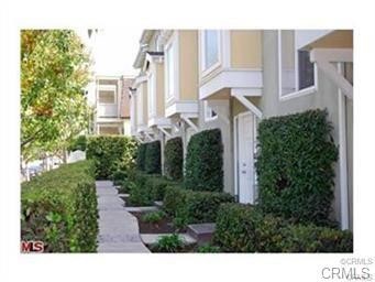 This gorgeous 3 bedroom townhome has it all! Gourmet kitchen with granite countertops, state of the art stainless steel appliances, custom cabinets and wine rack. Luxurious bathrooms with marble and travertine. Very light and bright living room with high ceilings, marble fireplace and a large balcony. Hardwood floors throughout, custom molding, double paned windows and an attached THREE car garage. Prewired for security, surround sound, satellite, cat V & an intercom. Located just over a mile from the beach, this one will not last!