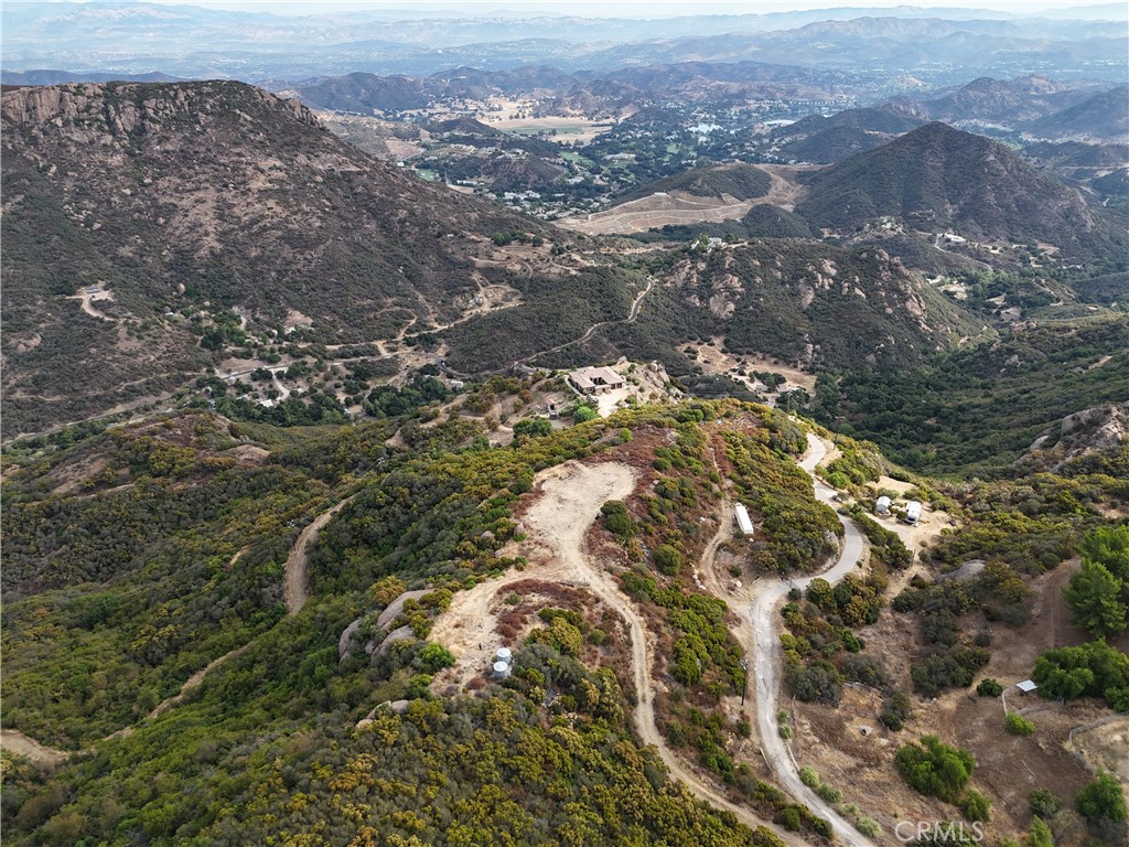 ** BUILDING PLANS COMPLETED** VIEWS OF LAKE SHERWOOD**
Discover a unique 10.76-acre property perched next to the scenic Santa Monica Mountains National Park, offering unparalleled 360-degree mountain, lake, and valley views. This prime location features multiple building pads perfect for creating a multi-home retreat, ranch, or estate. Enjoy a secluded yet accessible lifestyle with modern conveniences already in place, including county-approved agricultural well, septic system, and trenching for electric service. The property also includes modern ranch home building plans, along with a geo-technical engineering and grading report, ready for re-approval. The land offers two septic hookups, each placed at one of the largest flat building pads, and two 5,000-gallon stainless steel water storage tanks connected to the agricultural well. These tanks are fire-prepared and ready for installation of your own private fire hydrant, providing additional security. Located in the renowned Malibu Coast viticulture area (AVA designated in 2014), this property offers an ideal climate and location for growing grapes, surrounded by neighboring vineyards and wineries—perfect for starting your own boutique winery. Minutes from both the ocean and Westlake Village, this property is a gateway to endless outdoor adventures. Enjoy close proximity to hiking and biking trails like Backbone Trail, God’s Seat Lookout, and Sandstone Peak. Overlooking the prestigious Lake Sherwood private estates and PGA golf course, the property also offers sweeping views of Westlake’s city lights just beyond. Don’t miss this rare opportunity to own an exquisite piece of land.
