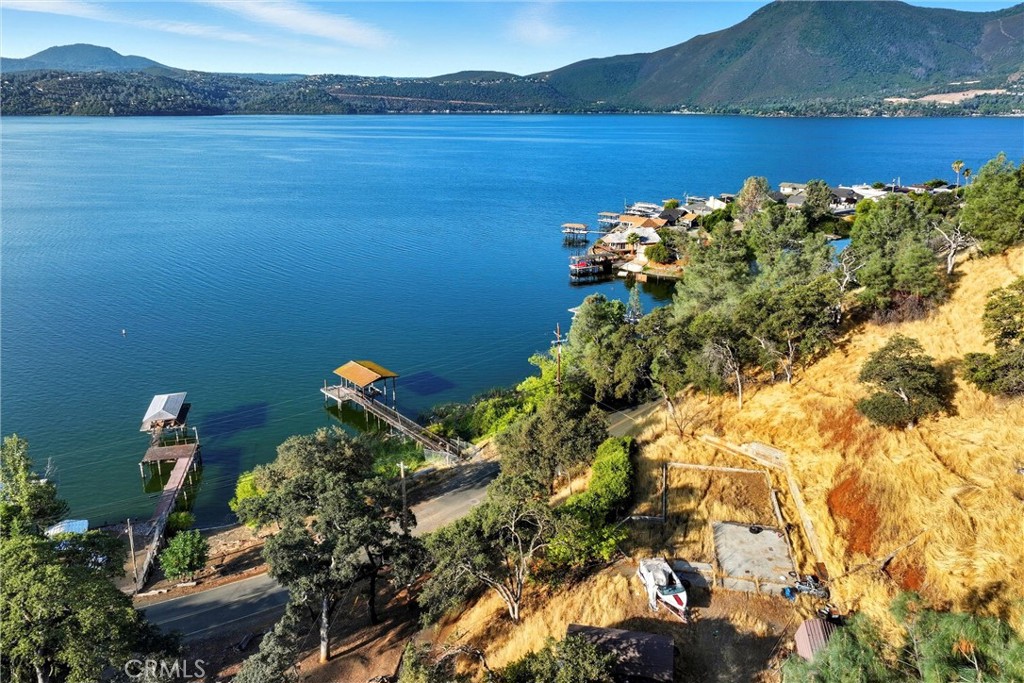 A rare opportunity awaits with this unique waterfront property made up of three separate parcels. With sewer and water already connected and R1 zoning, about 107 feet of waterfront, the groundwork is set for your next build. A previous 2-bedroom, 2-bath home ONCE stood here, giving you a clean slate while retaining established utilities. The property includes two oversized sheds for storage or project space, plus direct access to the lake with a dock, pier, and boat lift (in need of repair but brimming with potential). Whether you envision a dream home, a getaway retreat, or an investment opportunity, this setting combines convenience, utility, and lakefront living in one package.
