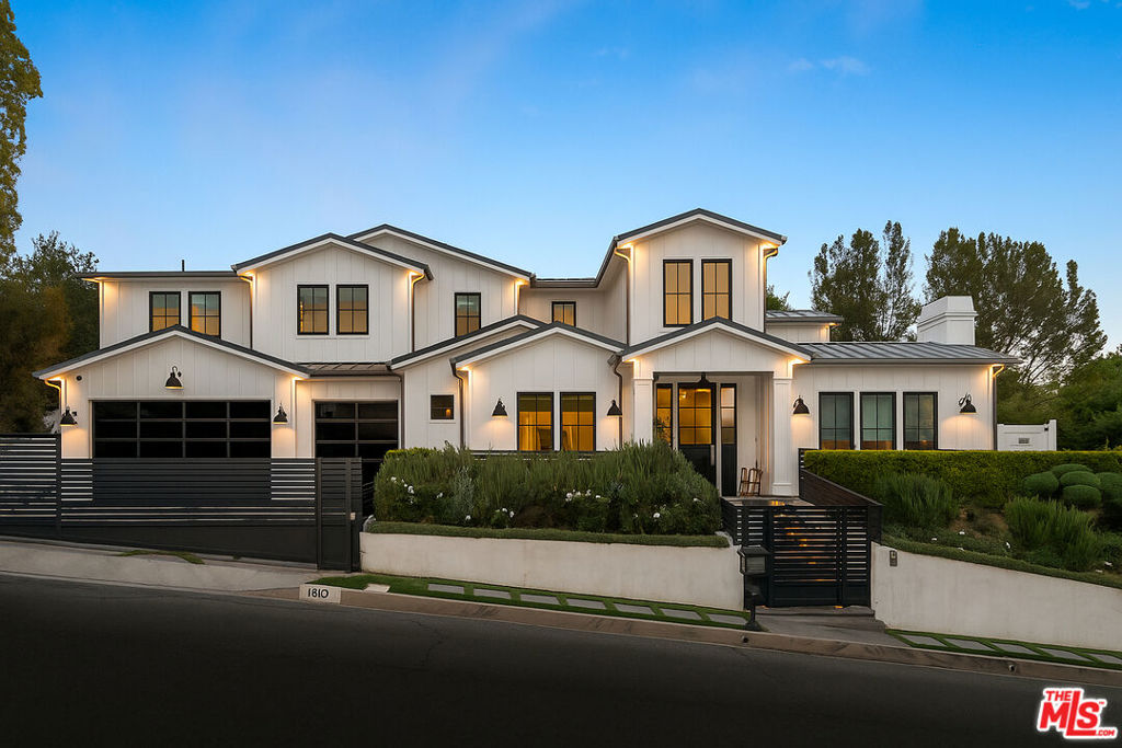 Welcome to this stunning modern-traditional home ideally situated on a quiet cul-de-sac in the highly sought-after enclave of Royal Oaks, Encino. Built in 2018, this newer construction (not a remodel) offers a limited builder warranty and is designed for the discerning buyer who values both elegance and modern conveniences. With impeccable curb appeal, the gated property immediately captures attention, inviting guests into a soaring foyer with high ceilings and European oak floors throughout. The elegant living room features a grand fireplace, seamlessly flowing into a formal dining room perfect for hosting. A glass-enclosed private office with custom built-ins provides a refined workspace with exquisite finishes. The heart of the home is the chef's gourmet kitchen, a true masterpiece. It boasts double islands with Calcutta quartz counters, a 60-inch Wolf range, a 72-inch built-in Sub-Zero fridge, a large walk-in pantry, and a butler's pantry. The spacious breakfast area is adjacent to a cozy family room, which showcases beautiful built-ins and a fireplace. Floor-to-ceiling pocket glass doors open to a sprawling entertainer's yard, creating a perfect indoor-outdoor flow. The main floor also offers a state-of-the-art home theater, a stunning powder room, a mudroom, and a wrought-iron, glass-enclosed wine cellar.Upstairs, the romantic master suite is a true retreat, featuring a sitting area and a dual-sided fireplace. The two expansive walk-in closets and a spa-like master bath complete with a soaking tub, glass rain shower, dual sinks, makeup vanity, and two water closets offer ultimate comfort and luxury. The entertainer's yard is a spectacular oasis with a zero-edge sparkling pool and spa, a fire pit, a built-in barbecue, and a pool house with its own bathroom. Thoughtfully designed for modern living, this home includes a full metal roof throughout, all underground utilities, a whole-house water filtration system, and smart home technology with integrated Control4. Additional features include a three-car garage and the option to purchase the home partially furnished. This exceptional residence offers a luxurious lifestyle just moments away from Encino's finest shops, dining, and more.