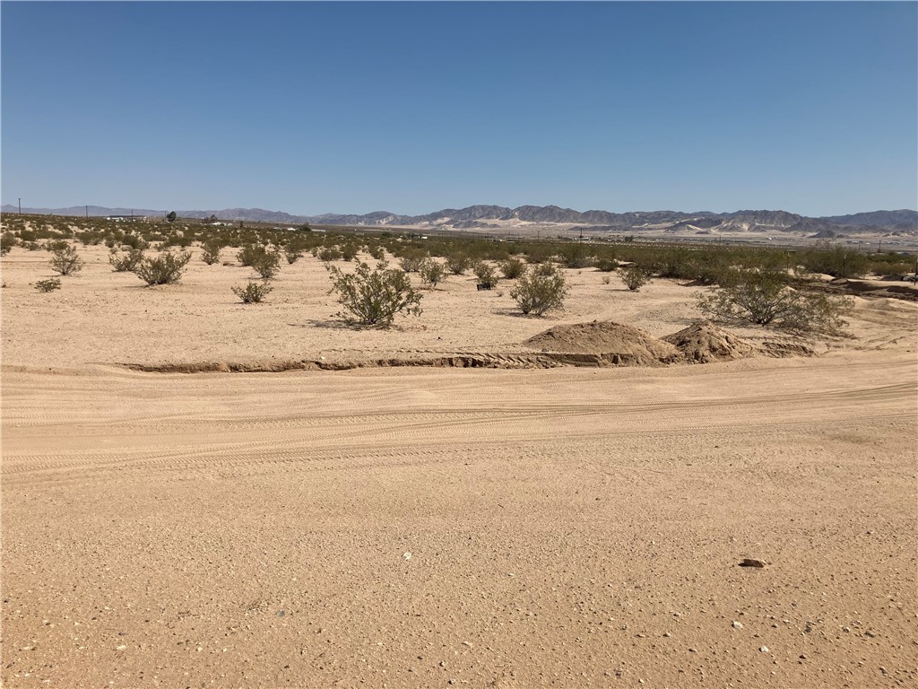 Enjoy the peace and quiet of Hi-Desert living! This Flat 5 Acre Parcel has water access and is located on a Very Desirable Corner Lot. Panoramic blue skies with amazing sun rises and beautiful starry nights is very inviting with close proximity to Joshua Tree National Park. Take a look!!