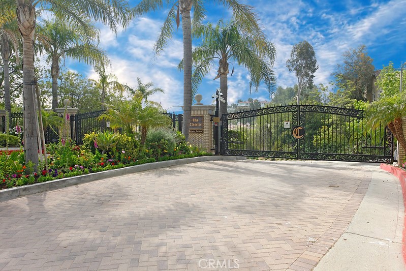 Entertainer’s POOL HOME in the GATED COMMUNITY of “The Classics Private Estates.” Located on a quiet cul-de-sac and on a HUGE 24,899 sq. ft. lot. Lush green topiaries, colorful flowerbeds, raised planters, swaying palm, mature shade tree, lighted stone pedestrian pathway and a covered portico enhance its eye-catching curb appeal. Double wood doors sweep open to a foyer with marble floors and drop-down lighting that leads to a bright and flowing open concept floor plan with a two-tone designer paint scheme throughout and approximately 3,208 sq. ft. of luxurious living space. Step-down formal living with clerestory windows, cathedral ceilings, dramatic marble surround fireplace and plush carpet. Open and bright family kitchen with gleaming windows, recessed lights, white cabinetry, under cabinet lighting, tile countertops, custom tiled backsplash, stainless-steel appliances which includes a center island with a 5-burner gas cooktop, built-in self-cleaning double oven and dishwasher; plus, a trash compactor, built-in microwave, SubZero refrigerator with cabinet panels, walk-in pantry and marble floors. Breakfast nook with sparkling window, window seating and drop down lighting. Formal dining room wrapped in clerestory windows, cathedral ceilings, drop-down lighting, plush carpet and French doors showcasing the backyard. Family room with a multitude of windows, brick fireplace with mantle, wet bar, plush carpet and French doors leading to the backyard. Oversized primary suite enriched by pitched ceilings, abundant picture windows, expansive retreat with fireplace and enormous walk-in closet; plus, a private en suite bathroom with dual basin vanity, tile countertops, built-in make-up vanity, soaking tub, glass-enclosed step-in tiled shower and privacy area. 2 upstairs bedrooms with sparkling windows, plantation shutters, ample closet space and plush carpet. Downstairs bedroom/private office with built-in storage and plush carpet. 2 additional guest bathrooms. 1 full bathroom with single vanity and glass-enclosed tiled tub/shower. Second bathroom with dual basin vanity and glass-enclosed step-in tiled shower. BONUS: Upstairs entertainment area with pitched ceilings, glistening windows, plantation shutters and plush carpet. Indoor laundry room with additional storage cabinets. Backyard features a multitude of flourishing and colorful flowerbeds, covered patio, open patio for al fresco dining, fenced in-ground pool and spa and handy storage shed.
