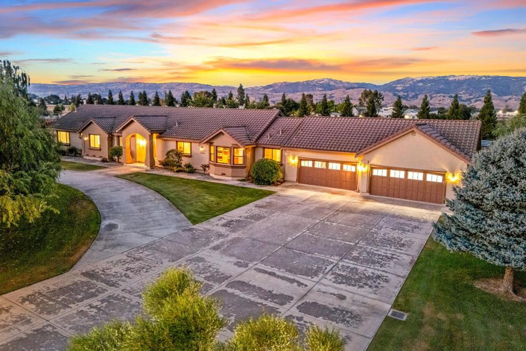 Beautifully secluded single-story estate with a 2019-built ADU, offering a total of 6 bedrooms and 6 full bathrooms. The property is surrounded on three sides by 160 redwood trees, providing natural beauty and privacy. The main residence features 4 beds, 4 baths, 4-car garage, entire inside has new paint and newly installed/refinished hardwood floors, formal living room, separate family room, and a dedicated office. Extra large kitchen boasts Subzero fridge, Dacor 6 burner gas stove top, GE Profile double oven, Kitchen Aid dishwasher and bright spacious dining area. The fully fenced backyard includes an inground pool, expansive lawn, gated play area, and privacy from the rest of the property. Equestrian and animal lovers will appreciate the large rectangular corral, an oval-shaped corral, 3-stall barn, and fenced dog run. On the left side of the main home, a private driveway lined with fruit trees leads to the ADU. This charming second home offers 2 bedrooms, 2 bathrooms, a wraparound porch with 6 outdoor leaf-blade ceiling fans, its own fenced backyard, a hot tub, a fenced in duck pond/water feature, front acreage with raised garden beds, and a full paved patio perfect for extended family, guests, or rental income. This must see listing is truly a one-of-a-kind property!