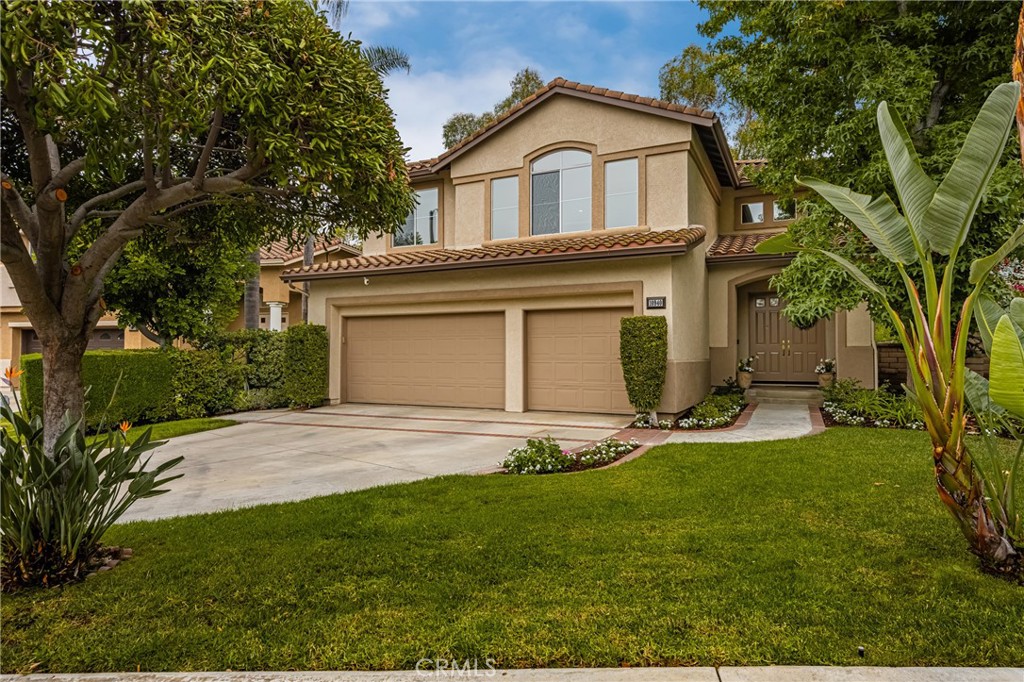 Live Work & Play in one of the best communities in the OC! Tustin Ranch is conveniently located in central Orange County w/easy access to golf, parks, Angels baseball & Ducks hockey stadiums, Disney, South Coast theatre, Newport Beach Fashion Island shopping, many beaches, John Wayne Airport & an easy commute to many local cities. 10940 Tantlinger is located in the desirable gated community of El Dorado just steps to top ranking schools, many parks, Tustin/Irvine Marketplace shopping, Tustin Ranch Golf Course & nestled amongst the hills of Peters Canyon offering year round beauty & outdoor fun!
This expansive home offers 4 bedrooms plus a huge bonus room that could be a 5th bedroom. One of the bedrooms is located on the main floor w/a large closet & would also be a great office space. Entering through the double doors the volume ceilings & natural light fill the formal living room. The kitchen was just updated w/NEW white Shaker cabinetry, satin hardware, elegant Quartz counters, single stack square backsplash & large custom island w/seating. The elongated cabinetry w/upper glass cabinets, island & pantry offer an abundance of storage. The kitchen & family room seamlessly flow together & are a great gathering place for friends & family.
The primary bedroom suite offers privacy with its thoughtful location on the back of the home & offers a large retreat w/fireplace that makes a wonderful additional flex space for work out equipment or office space. The primary bath is complete with soaking tub, walk in shower, dual vanity sinks, new custom mirrors & lighting as well as a huge closet w/custom organizer. On the other side of the home there are two additional bedrooms & a huge bonus room w/custom built in cabinetry. New light fixtures & mirrors were recently installed as well us luxury vinyl plank wood look flooring in the hall bath. Additional features include hardwood plank & tile flooring as well as newer upgraded carpeting upstairs. Double sliding glass doors lead to a private sprawling patio w/custom raised masonry planter beds & lovely views of the surrounding hills & trees.
Tucked within the private gates of El Dorado are an association pool, spa, playground, BBQ area & a huge grassy green belt for kids & dogs to frolic. El Dorado familes come together for annual neighborhood events such as a 4th OF JULY parade, ice cream truck, summer movie nights, cornhole tournament & winterfest.