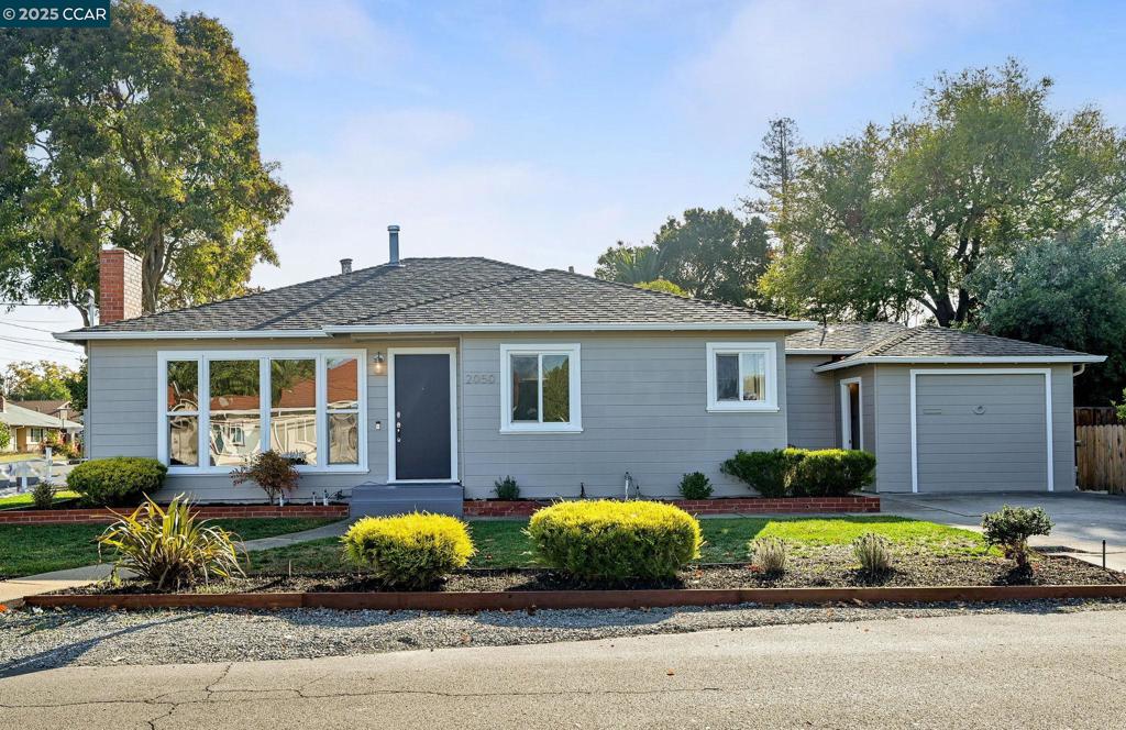 OPEN SAT/SUN 1-4! Nestled in the heart of Concord, this updated and light filled home invites you to settle in and stay awhile. Step through the front door into the  bright, open living room where sunlight pours through the picture window and a wood-burning fireplace promises cozy evenings. Recessed lighting, dual-pane windows, central AC, and updated flooring blend comfort with efficiency and keep energy costs satisfyingly low. Step through to the open kitchen and breakfast nook, with expansive stone countertops and a space perfect for a coffee bar, stainless steel appliances, generous cabinetry, and a large split sink that make gathering effortless. Mornings here start easy; family holidays feel special. With three bedrooms and two full baths, there’s room for everyone. An additional home office with its own outdoor access is perfect for remote work or a private yoga space. Step outside to wide, level yard with a pergola and storage shed made for play, gardening, or weekend get-togethers. The semi-finished garage extends your space for storage, projects, and hobbies, plus off-street parking and an EV charger. All just minutes from BART, Safeway, Todos Santos Plaza, restaurants, shopping, and schools. Welcome home!