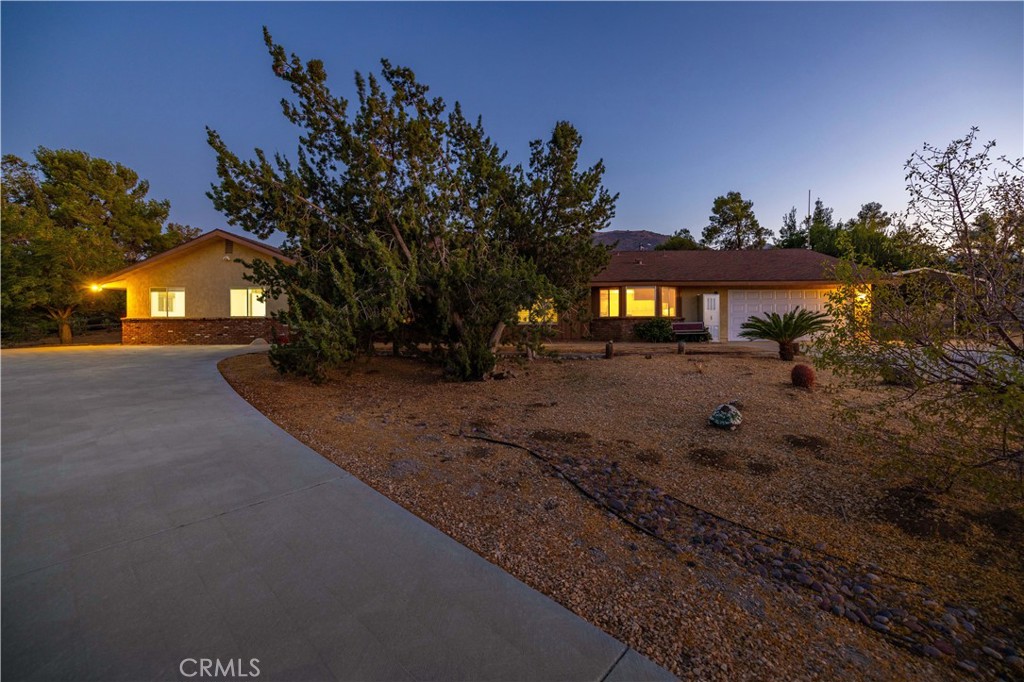 Welcome to 626 Westlake Dr! Enjoy the rare luxury of an indoor pool, perfect for year-round swimming, relaxation, and entertaining in the comfort of your own home. Located in a prestigious West Palmdale community on Ana Verde Hills, with easy access to freeway, shopping, and parks, this property combines convenience with privacy. A circular driveway framed by desert landscaping leads to the inviting home, where new flooring flows throughout and a step-down living area is anchored by a cozy fireplace. The kitchen offers ample cabinetry, abundant storage, and oversized windows showcasing stunning mountain views. This spacious property includes two fireplaces, generously sized bedrooms, modestly updated bathrooms, and an enclosed patio for extra year-round living space. Outside, you'll find an oversized 4-car garage, covered parking ideal for an RV, boat, or your favorite toys, leased solar for energy efficiency, and plenty of room to park additional vehicles, keep horses, build an ADU, or create your dream outdoor setup. With its indoor pool, private setting, and one-of-a-kind desert charm, this stunning home offers endless possibilities and is truly a must-see!