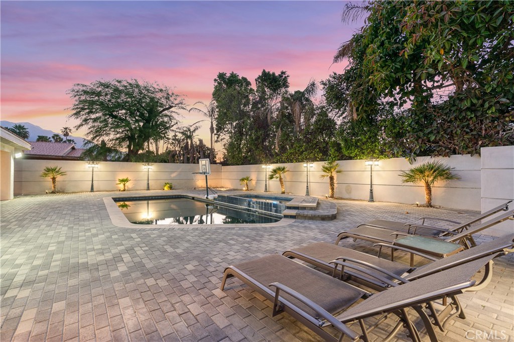 Welcome to your fully furnished luxurious retreat nestled just a stone's throw away from the vibrant energy of Palm Springs and the sophistication of Palm Desert. This impeccably renovated 4-bedroom, 4-bathroom haven boasts the perfect blend of modern elegance and desert tranquility. As you step inside, you're greeted by an inviting open floor plan that seamlessly connects the spacious living areas, all radiating with contemporary charm and comfort. The home features a brand new custom kitchen complete with a sleek wet bar, ideal for entertaining in style. The bathrooms have been thoughtfully redesigned with modern finishes, offering a spa-like ambiance throughout. A dramatic vaulted ceiling in the family room enhances the sense of space and airiness, making it a perfect gathering spot for relaxing or hosting. Every detail has been carefully curated to deliver an elevated lifestyle experience in one of the desert’s most desirable locations.