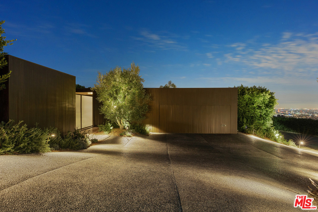 The perfect combination of chic and elegant. Stunning international pavilion style estate reimagined by famed architect Marmol Radziner. This home features panoramic city to ocean views and tasteful interiors. Includes formal entry court, office, and gym. Walls of glass expose natural daylight and striking views. Herringbone brick floors throughout and neutral cabinetry create refined and sophisticated palette. Experience true California indoor-outdoor lifestyle; large living area is equipped with floor-to-ceiling windows, which open up to covered patio, gracious pool, and fire pit. Located in close proximity to Beverly Hills shops and restaurants.