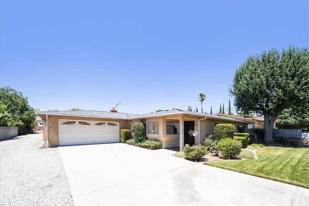This property offers breathtaking views of the mountains and is conveniently located near schools, parks, bike trail, shopping centers, and freeways. It is comprised of three bedrooms and two bathrooms within a spacious 1,700 square feet. The set-back and greenery gives this property plenty of privacy. Besides a formal living room at entry leading into a formal dining room, it features a hang-out kitchen that opens to the family room. The family room is completed with a cozy fireplace which steps out to a patio ideal for gatherings and fun in the sun. The primary bedroom is very spacious and features wall to wall closet space with extra storage above. The additional two bedrooms are also very extra in size with great closet space and storage.
In addition to a traditional 2 car garage with laundry and direct access, the dwelling also includes a four-car garage/work shop for all the "Do It Yourselfers" and hobby mechanics. A long, graveled driveway provides access throughout the oversized property with options to build an ADU (Accessory Dwelling Unit), sports court, and/or pool for everyone to enjoy. Although the home seems démodé, it features an upgraded kitchen, stainless steel appliances, scarped ceilings. In addition the bathrooms have upgraded vanities and tile flooring as well as a remodeled shower in the primary bath.This home needs only cosmetic improvements and some love to move right in. It is awaiting its next owner to call it home.