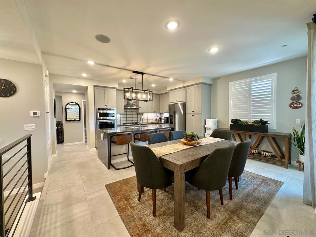 Location. Views. Income Potential — A Rarely Offered Model Home That Truly Has It All! Nestled in the heart of Poway, this stunning 2-story model home delivers the perfect blend of luxury, lifestyle, and investment potential. With unobstructed park views, full builder upgrades, and elegant designer finishes, this is a rare opportunity you won’t want to miss. Originally built as the builder’s showcase model, the home comes fully loaded with every available upgrade, offering turnkey comfort and lasting value. On the first floor, enjoy the versatility of a private-entry Multi-Gen Suite, complete with its own bedroom, living area, kitchenette, and laundry, Luxury epoxy flooring and built-in shelving in the garage, perfect for extended family, guests, or rental income. The second floor boasts a bright open-concept layout with a spacious great room, KitchenAid stainless steel appliances, oversized island, dedicated laundry area, and custom wood shutters, all overlooking Poway Community Park through expansive windows and a serene covered balcony. Direct Park Access Just 5 Seconds Away! Right across the street, Poway Community Park offers a dynamic lifestyle with a Swim Center, fitness areas, playgrounds, dog park, and rolling green meadows, ideal for outdoor living without the maintenance. You’ll also enjoy access to a newly updated tennis court, skate park, and senior community center. A peaceful brook winds through the park, often visited by ducks — a charming, natural touch to your surroundings. This exceptional home checks every box — and it won’t last long.