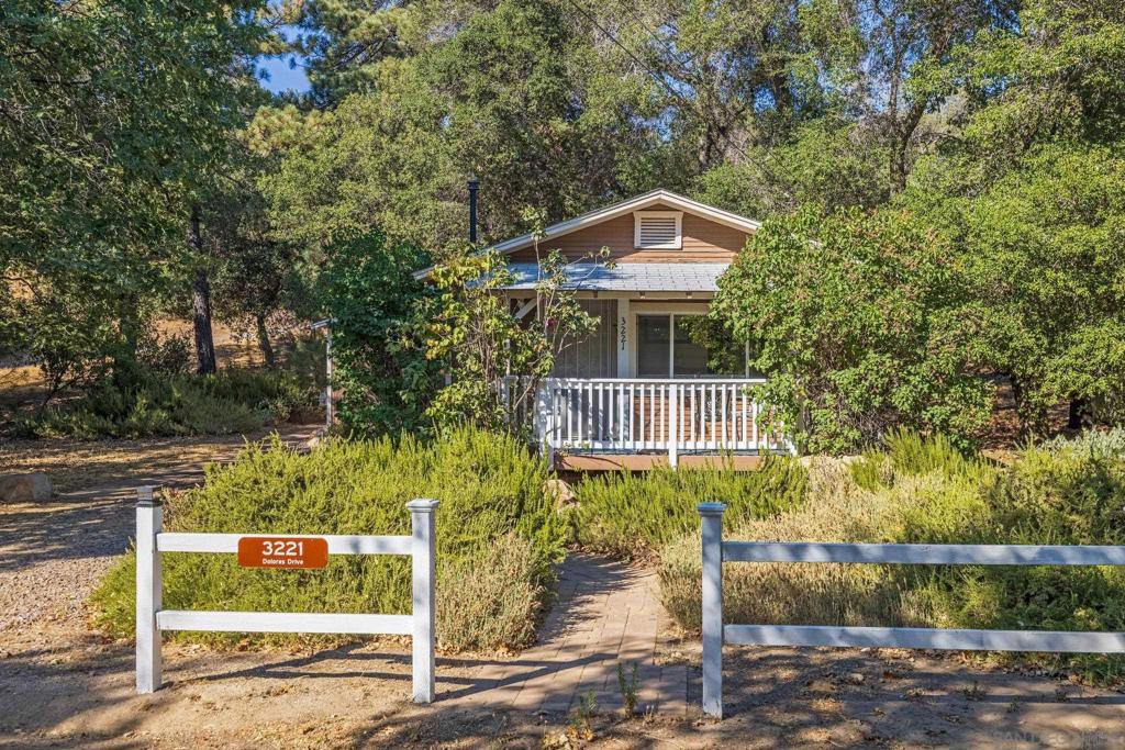 Charming vintage cottage has been updated and is move-in ready. 1 bed/1ba with a bonus spot perfect for home office or a fold out couch. An extra vacant lot comes with the house, offering .45 acres of privacy and beautiful oaks and pines for a true country feeling. With two newer mini-splits, a pellet stove, thermostat controlled baseboard heat, granite counters, laundry room, updated bathroom, 2 storage sheds, this immaculate home is on a paved county-maintained road. This is the cabin in the trees you've been waiting for!