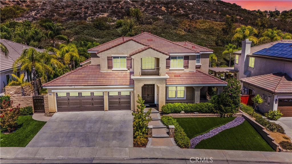 Behind the gates of Murrieta Heights, discover a home where thoughtful design meets everyday livability. 23850 Hollingsworth Dr offers a beautifully updated interior filled with natural light, soaring ceilings, and a layout that flows effortlessly from room to room. At the heart of the home, the chef’s kitchen stuns with an oversized quartz island, stainless appliances, and a walk-in pantry—opening seamlessly to the family room for easy connection. The downstairs primary suite feels like a true retreat, complete with a spa-inspired bath and dual walk-in closets. Upstairs, a spacious loft and private ensuite guest room offer versatility for family or guests. Step outside to a backyard built for entertaining, featuring a rock waterfall pool, spa, built-in BBQ, and bar seating—all framed by mature landscaping and total privacy