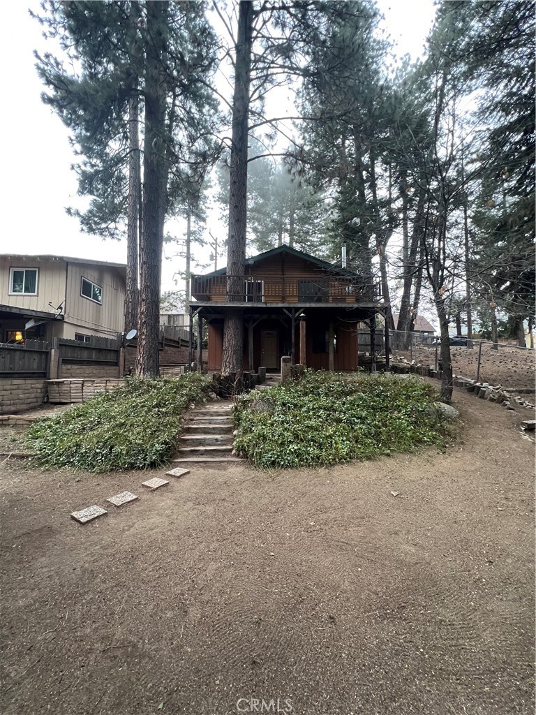 Recently taken off the market to extensively revitalize the interior by intensively scouring and polishing the walls, floors and carpets. Now, the halls have a distinctively light and airy scent to them and give the quality of a diamond brought back to brilliance. Price Reduced. Owners have moved. Tucked among mature pines yet walking distance to local cafés, shops, the playground, post office, and Snow Valley, this classic log cabin blends rustic charm with modern comfort. Inside, a vaulted great-room ceiling and rich parquet flooring create an airy lodge feel, anchored by a high-efficiency wood-burning stove installed less than two years ago. Fresh ceilings in the living room and bedrooms, upgraded electrical, and one of the few homes on the mountain with a Nest-controlled central air-conditioning system added last year ensure year-round ease. The open kitchen features a nearly new, warranty-protected refrigerator, while the bathroom showcases designer tile, a custom countertop, statement backsplash, and a brand-new toilet. Worry-free living continues with updated sewer lines, perimeter drains, and a professionally sealed foundation completed six years ago. Beyond the tiled entry, an expansive deck invites summer lounging beneath the trees, and a large, level parking pad, fenced yard, and roomy Tuff Shed make mountain life effortless. Simply move in and start making cabin memories.