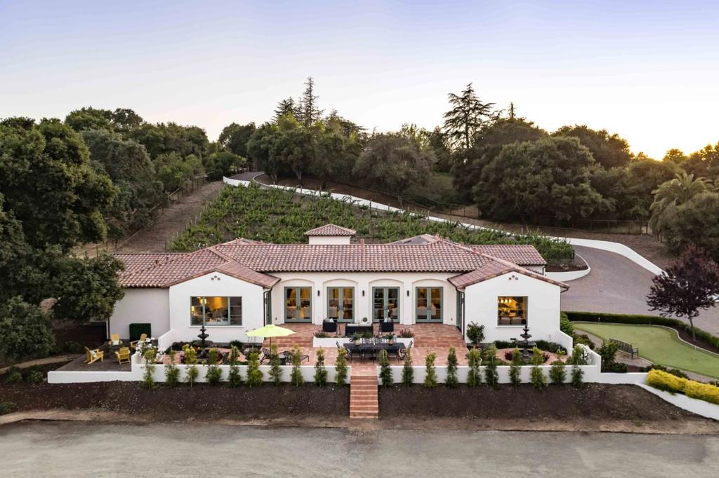 This exceptional estate rests on over 2 acres of land, evoking the essence of the Napa countryside. A winding driveway flanked by lush chardonnay vines guides you to an expansive custom home showcasing gorgeous Mediterranean design, boasting nearly 4,900 sf of meticulously appointed interiors. Whether hosting grand gatherings or enjoying a quiet night, this home caters to every need, featuring a large living room and family room separated by a two-way fireplace, a chef's kitchen, office, media room, and wine cellar. Six en suite bedrooms provide accommodations, with the primary suite offering a spa-inspired retreat. And while the peaceful grounds will leave you with overwhelming feelings of serenity and seclusion, this property is within walking distance of vibrant downtown Los Altos, 10 minutes from two spectacular golf and country clubs, and close to the campuses of Tesla and VMware. Plus, children may attend top-ranked schools including Los Altos High (buyer to verify eligibility).