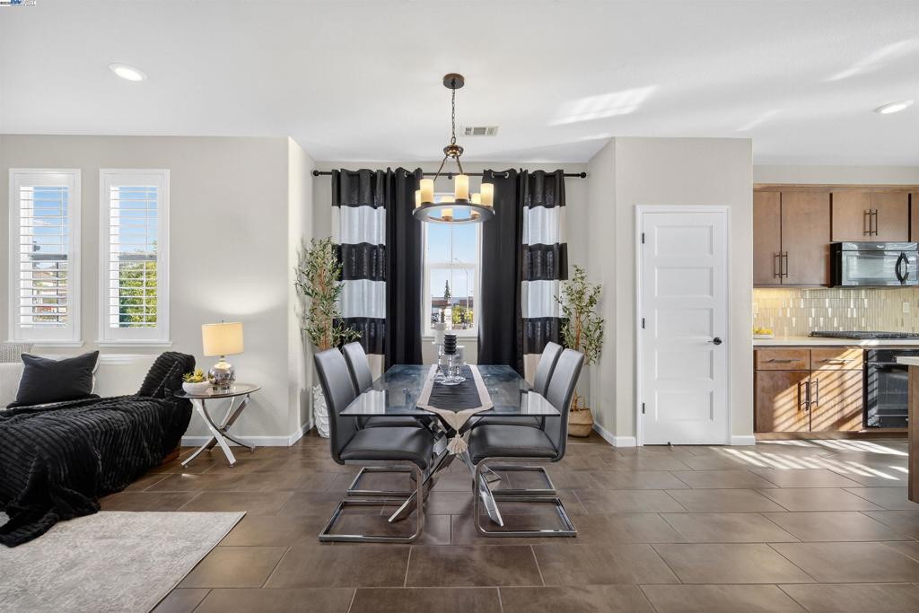 Experience unobstructed panoramic views of the Mission Hills from this stunning 4 bed, 3.5 bath KB Home model residence, showcasing over $120,000 in upgrades. As the last model home sold in the community (2018), it stands out as one of a kind—blending luxury design, a central location, and resort-style living. Tall windows throughout flood the home with natural light. The east-facing living room and primary suite glow with morning sun, while the kitchen and secondary bedrooms enjoy warm evening light. From sunrise to sunset, every room feels bright and uplifting. The thoughtful layout includes a full bedroom & bath on the entry level, a spacious primary suite with walk-in closet, crown molding & accent wall, plus bathrooms with custom backsplashes. The chef’s kitchen boasts Caesarstone counters, Barbosa cabinets, pantry, and recessed lighting. Additional highlights include a separate laundry room, half bath on the main level, and recessed lighting throughout the home for a modern, elegant finish. Unbeatable Location: Walk to Starbucks, Raising Cane’s, Curry Pizza House, Chipotle, Sprouts, CVS, In-N-Out, Ross & HomeGoods. Just 2 minutes to Mission Blvd, 5 minutes to Hwy 92, and close to I-880 & BART for seamless commutes to SF & Silicon Valley. Near Mission Hills Golf Course