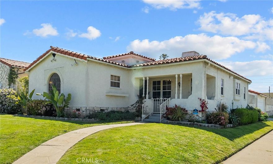 Welcome to this charming Spanish Revival 3 bedroom, 3 bath home in the heart of Los Angeles. Each bedroom offers its own full bath, providing comfort and privacy for families, guests, or shared living. The primary suite feels like a retreat with hardwood floors, a walk in closet, and a spa inspired marble bath with a soaking tub, separate shower, and dual vanities. The additional bedrooms offer great natural light, hardwood floors, and updated baths. Recent upgrades include a full re pipe in 2021, updated electrical, original hardwood floors, and new marble, tile, and laminate finishes. The gourmet kitchen features Bosch appliances, a seven burner chef's stove, and a French door refrigerator. The living and dining areas are centered around a restored fireplace, vintage Deco era fixtures, and curved plaster ceilings, blending classic 1930s character with modern updates.  Outside, enjoy a private backyard with a patio, BBQ area, and garden. The two car garage provides parking or storage.  Additional features include a security system, and a spacious courtyard.  Set on a manicured corner lot less than two miles from SoFi Stadium and minutes from LAX, USC, Marina del Rey, Venice Beach, and UCLA, this home delivers style, comfort, and convenience.