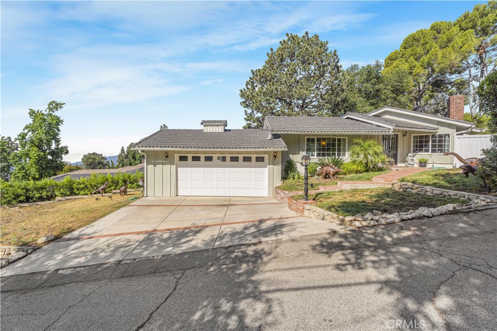 Welcome to this inviting 3-bedroom, 2-bathroom home in the highly sought-after Briggs Terrace neighborhood of La Crescenta. Situated on a flat 8,808 sq ft lot, this 1,485 sq ft residence offers a comfortable layout filled with natural light, featuring large windows and multiple doors that open seamlessly to the outdoor living areas. So close to restaurants, shopping, and freeways...yet the quiet privacy is hard to beat.
The main bedroom includes a private ensuite (3/4 bath), while a full bathroom for guests and family is in the hallway. The bright kitchen takes in stunning views of downtown Los Angeles and beyond, creating a perfect backdrop for daily living. Appliances are included, and the home provides abundant storage both inside and in the attached 2-car garage. The expansive, fully fenced backyard is ideal for entertaining, gardening, or future possibilities such as an addition or pool. Adding to its charm, the outdoor spaces are accented with whimsical dinosaur décor, bringing a playful and distinctive character to the property. Located within the boundary of the highly regarded Mountain Avenue Elementary School, this home combines comfort, convenience, and opportunity. Don’t miss your chance to own a home in this desirable La Crescenta community!
Photos were taken when the home was staged. It no longer has staging. Small dogs (30 lbs or less) are ok with breed restrictions.