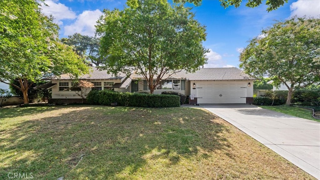Welcome to this delightful mid-century ranch nestled in the heart of Claremont. This beautiful home boasts gleaming original hardwood floors, a hallmark of 1950s craftsmanship, as they create an elegant and inviting ambience. The house has been freshly painted and is open and bright. Lots of windows allow for the natural light to bathe the rooms. As you move through the house, you will be impressed by the generous size of the rooms. The formal living room provides the perfect space for special occasion entertaining and visits with friends and family. As you move into the family room, you will be happy to see the cozy fireplace and sliders that open out to the backyard. The kitchen is a chef's delight. Gorgeous granite countertops are a focal point. The modern cabinets provide the perfect space for all of your storage needs. Off the kitchen, you will find the indoor laundry area. Travel down the hall to find the family quarters. The secondary bedrooms are very spacious. The hall bath has been beautifully updated with high-end fixtures, tile work, and refined finishes. The primary bedroom has dual closets and easily accommodates a king-size bed. The primary bath has also been beautifully renovated. The yard is beautiful and is the perfect place to set up a game of badminton. This home is located on a quiet, tree-lined cul-de-sac. It is located just north of Vista Del Valle Elementary School and Wheeler Park. It is also a short stroll to the vibrant Village of Claremont. There you will find shops, restaurants, and entertainment. The prestigious Claremont Colleges are also a short walk away. This home is commuter-friendly as it is located between the 10 and 210 freeways, without any freeway influence. It is also very near the MetroLink station and various bus lines, making public transportation a breeze. This home blends historic warmth with modern refinement. You must come to see this one soon! It won't last!
