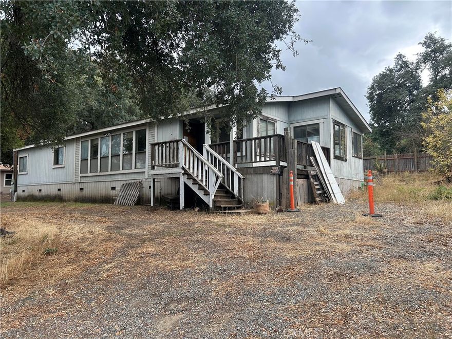 Welcome to a golden opportunity nestled in the picturesque community of Clearlake. This 3-bedroom, 2-bathroom double-wide manufactured home awaits your visionary touch. Sitting on an expansive lot with ample space for outdoor activities and gardening dreams, this property offers endless potential. The open kitchen design flows effortlessly into the living area, creating a welcoming atmosphere for family gatherings or entertaining guests. Large windows allow natural light to flood the interior, highlighting the home's generous proportions.



The master suite provides a private retreat, complete with an en-suite bathroom ready to be transformed into your personal oasis. Two additional bedrooms provide flexibility for a growing family or can easily cater to your office needs.



While this home requires some TLC and creative updates to unlock its full charm, it stands as a canvas ready for your designer flair and imagination! Conveniently located close to lakeside amenities, shopping centers, and schools—this property is ideal for those who relish both relaxation and community life.