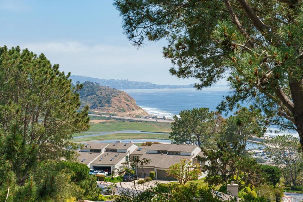 Welcome to Villa Torrey Pines, an exquisite coastal retreat nestled at the South end of Del Mar, offering miles of breathtaking views through Torrey Pines State Nature Reserve, all the way past La Jolla. This custom home perfectly blends modern luxury, relaxed beachside living, and ultimate privacy, making it an ideal haven for those seeking the quintessential Southern California lifestyle. As you enter the home, you're greeted by a massive front door adorned with custom stained glass. The entryway features a floor-to-ceiling water feature that encircles the foyer and extends beneath the staircase, creating a tranquil indoor/outdoor ambiance. Throughout the home, custom Jatoba floors gleam with warm light, set against the lush backdrop of Torrey Pines trees and blue ocean. The main living room offers expansive ocean views through Torrey Pines State Beach, a custom stone fireplace/wall, and bespoke Mahogany cabinets. Adjacent to this space is the dining area, which also boasts ocean views, and a separate office area with a built-in desk and custom storage/cabinets. The gourmet kitchen is equipped with top-of-the-line stainless steel appliances, granite countertops, custom cabinetry, intricate lighting, and a large center island. The illuminated stone pantry is a chef's dream, offering ample storage and prep space. Two guest bedrooms, each with their own full bathrooms, have access to the outdoor view deck and ocean views. Plus, a dedicated laundry room and powder room completes the first level of the home. The luxurious primary suite occupies...See supplement... The luxurious primary suite occupies the entire top level, offering stunning views of the ocean and reserve. This spa-like suite exudes warmth and coziness with custom wood throughout, fireplace, and sitting area. The private bathroom features double vanities, bathtub, and a glass-enclosed shower. The walk-in closet provides ample space and storage, a light-up stone floating island with additional storage, and a picture window showcasing ocean views. The beautifully landscaped backyard is an outdoor oasis, featuring a massive wraparound wooden deck, multiple seating areas, BBQ, a giant fire bowl, a built-in outdoor dining set with fire pit, all overlooking the famous Torrey Pines State Beach—a serene spot to enjoy breathtaking sunsets and ocean breezes. Parking is convenient with a three-car garage featuring custom stone flooring, ample storage, and additional driveway parking. Located in the prestigious community of Del Mar, this home is just minutes from pristine beaches, top-rated schools, and vibrant shopping and dining options. The location also offers easy access to major freeways and public transportation for a seamless commute. Discover the unmatched beauty and tranquility of Villa Torrey Pines. This exceptional Del Mar home is a rare find, boasting panoramic views and the utmost quality finishes. Designed by Dean Meredith and constructed by Peter Madsen, only the finest materials and natural products were used to create this masterpiece. Welcome home.