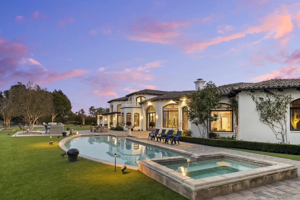 Commanding a premier location on 1 beautifully manicured acre in the coveted Rancho Pacifica gated community, welcome to 4650 Rancho Del Mar Trail. With mesmerizing, panoramic views of the Fairbanks Ranch Golf Course, mountains and valley enjoyed throughout the 12,657 SF estate, this home is sure to impress even the most discerning. The 6 bedroom + office main house and 1 bed, 1 bath guest house are each graced with magnificent scale, an abundance of natural light and an open floor plan ideal for seamless indoor/outdoor living. Adding to the convenience afforded here, the main level boasts dual living spaces, formal and informal dining, generous chefs kitchen with a walk-in wine cellar, sumptuous primary suite, two additional bedroom suites, a stunning wood paneled library, and versatile bonus space, perfect for a fitness center, theatre, nursery or secondary office. Outside, the extensively renovated grounds invite endless entertaining while enjoying the spectacular natural backdrop and space for making memories with friends and family with the resort-style pool and spa, built-in BBQ, sitting area, outdoor dining, spacious lawn and more. Located moments from the finest shopping and dining of both Rancho Santa Fe and Del Mar, this location truly cannot be beat! Commanding a premier location on 1 beautifully manicured acre in the coveted Rancho Pacifica gated community, welcome to 4650 Rancho Del Mar Trail. With mesmerizing, panoramic views of the Fairbanks Ranch Golf Course, mountains and valley enjoyed throughout the 12,657 SF estate, this home is sure to impress even the most discerning. The 6 bedroom + office main house and 1 bed, 1 bath guest house are each graced with magnificent scale, an abundance of natural light and an open floor plan ideal for seamless indoor/outdoor living. Adding to the convenience afforded here, the main level boasts dual living spaces, formal and informal dining, generou