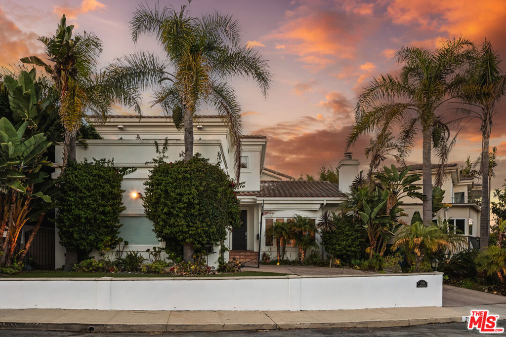 Experience the essence of coastal California living in this beautifully crafted 5 Bdrm/4 Bath home perched atop the hills of Playa del Rey - just moments from the sand w/ views, views, views! Enjoy ocean breezes and stunning views from this elevated retreat where timeless charm meets everyday comfort. Surrounded by lush landscaping and rich architectural character, the home welcomes you with warmth, elegance, and a relaxed coastal spirit. As you enter, a formal living room with a cozy fireplace sets the tone - ideal for both quiet evenings and lively gatherings. The light-filled kitchen features custom cabinetry, Carrara white quartz countertops, top-of-the-line appliances, and a breakfast bar. A formal dining room flows into a spacious family room, where French doors open to a dreamy backyard with a cascading waterfall, bubbling hot tub, and lush tropical foliage - large enough to dine alfresco under the stars. Upstairs, the primary suite offers a travertine-framed fireplace, walk-in closet, spa-like bath, and balcony with peaceful patio views. Another spacious bedroom enjoys sweeping ocean and treetop vistas from its own private balcony - perfect for sunset gazing. All just moments from Playa Provisions, Bacari PDR, walking trails, and nature preserves - offering the best of beachside living with a true neighborhood feel!