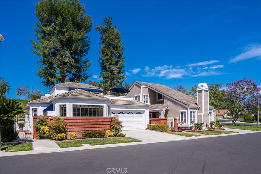 This tastefully remodeled Pebble Beach with a loft model is ideally situated near the end of a quiet cul-de-sac with only eight homes, offering a peaceful setting with expansive greenbelt surroundings and gorgeous views of Lake Mission Viejo — the perfect place to unwind, watch the fireworks, or enjoy nature year-round.



Step inside and be greeted by vaulted ceilings, abundant natural light, and a layout designed for comfort and ease. The beautifully remodeled kitchen (2019) is a standout feature, boasting high-end KitchenAid stainless steel appliances (2022), upgraded cabinetry, and a cozy breakfast nook — an ideal spot to savor your morning coffee.



The kitchen and formal dining area showcase elegant wood flooring, blending warmth and sophistication. The inviting living room with soaring ceilings flows seamlessly to a private covered patio, perfect for quiet moments or entertaining.



The spacious primary suite is a true retreat with vaulted ceilings, a walk-in closet, dual vanities, and a skylight in the remodeled master shower that brings in soft, natural light. The second downstairs bedroom is perfect for guests or a home office, adjacent to a full bath.



Upstairs, a versatile loft offers privacy and flexibility — ideal for overnight visitors, caregivers, or grandkids. It features its own recently remodeled full bath and a private sun deck to relax, read, or sip wine while soaking in the serene surroundings.



This home also features a newer HVAC system (1.5 years old), freshly painted interior and exterior, three fully remodeled bathrooms with timeless finishes, and a garage with ample storage — perfect for keeping everything organized.



From the walls of windows that flood every room with light to the peaceful rear deck and unbeatable location, this home is a true gem. Enjoy resort-style living with access to pools, tennis, clubhouses, fitness centers, walking trails, and the beauty of nearby Lake Mission Viejo.