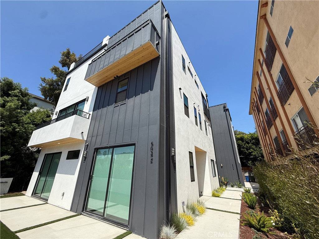 Welcome to Unit 1 of this sleek and modern tri-level triplex, boasting 4 bedrooms, 3.5 baths, and approximately 1,514 square feet of thoughtfully designed living space. Enjoy the perfect blend of style and functionality with contemporary finishes, high ceilings, and wide-plank flooring throughout. The open-concept main level features a spacious living area, a designer kitchen with quartz countertops, custom cabinetry, and stainless steel appliances. All bedrooms are generously sized, including a primary suite with a walk-in closet and en-suite bath. Step up to your private rooftop deck, ideal for outdoor entertaining, dining, or simply enjoying panoramic views. Additional features include in-unit laundry, central HVAC, and gated entry. A rare find in a central location close to shops, dining, and entertainment.