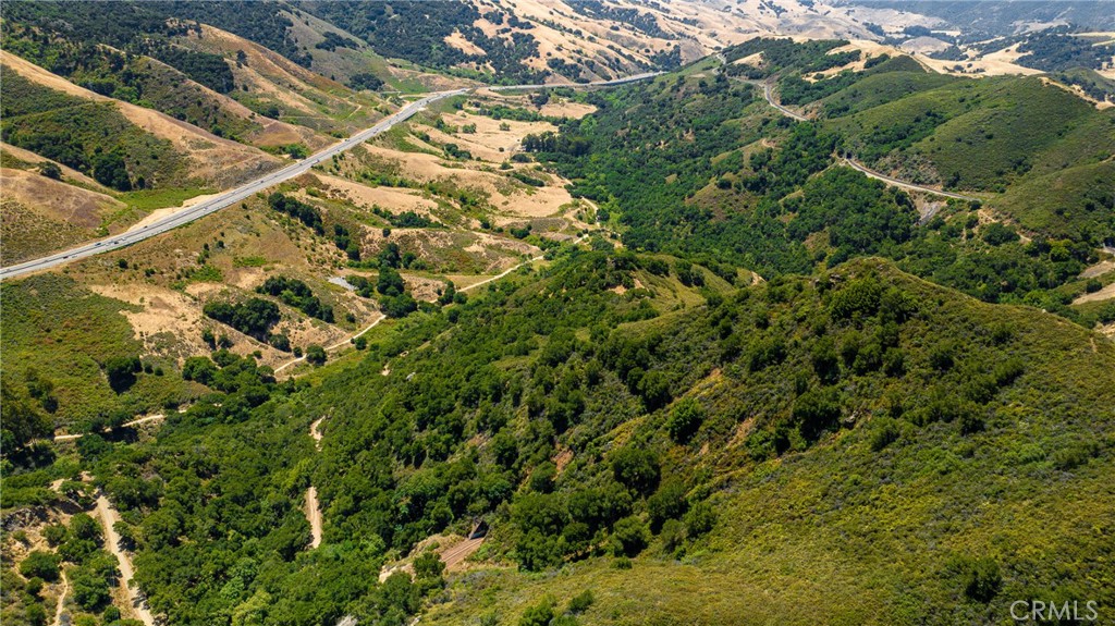 This pristine 77-acre parcel sits tucked into the ridge-line just north of San Luis Obispo. It’s accessible via Old Stagecoach Road from the top-side trailhead or the more rustic back-road from below.
A lightly forested, elevated bench provides a natural homesite site, offering unfolding outlooks across the Cuesta Grade corridor toward San Luis Obispo. The gradual terrain ensures privacy without feeling remote.
Bordering the well-traveled West Cuesta Ridge Trail—a popular run for hikers and mountain bikers—the property offers connection to an established outdoor network. Yet it remains just minutes from city conveniences. With this parcel, you’re buying scenic potential and the chance to build your retreat above it all on Cuesta Ridge.