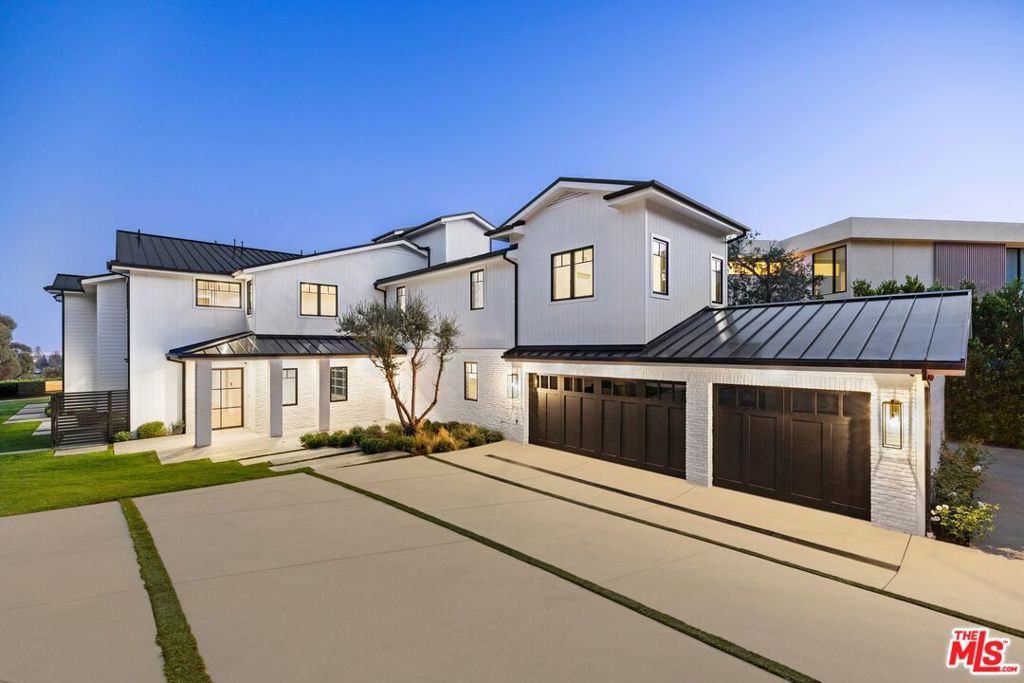 Tucked at the end of a cul-de-sac, this brand-new 10,500 sq. ft. Brentwood estate blends clean modern design with resort-style amenities and sweeping Pacific Ocean and city views. The main level offers formal living and dining rooms, a front office, and an open-concept family room that flows into a chef's kitchen with Wolf appliances, porcelain counters, butler's pantry, and breakfast nook. Walls of glass open to a grassy yard, infinity-edge pool, and outdoor kitchen with BBQ ideal for entertaining. The home features 7 ensuite bedrooms, including a downstairs suite and a spectacular primary retreat with dual vanities, soaking tub, oversized shower, and a private balcony overlooking the ocean. Four additional guest bedrooms each enjoy their own baths on the upper level. A pajama lounge and upstairs laundry add convenience. The lower level is an entertainer's dream with a basement bar, temperature-controlled wine room, private theater, gym, steam room, and flexible space perfect for a second office. Additional highlights include an expansive upper deck with panoramic views, metal roof, elevator, multi-zone HVAC, central vacuum, alarm system, mud/laundry room with dog wash, and 3-car garage. This is a rare opportunity to lease a newly built, private estate combining elegance, function, and breathtaking views.