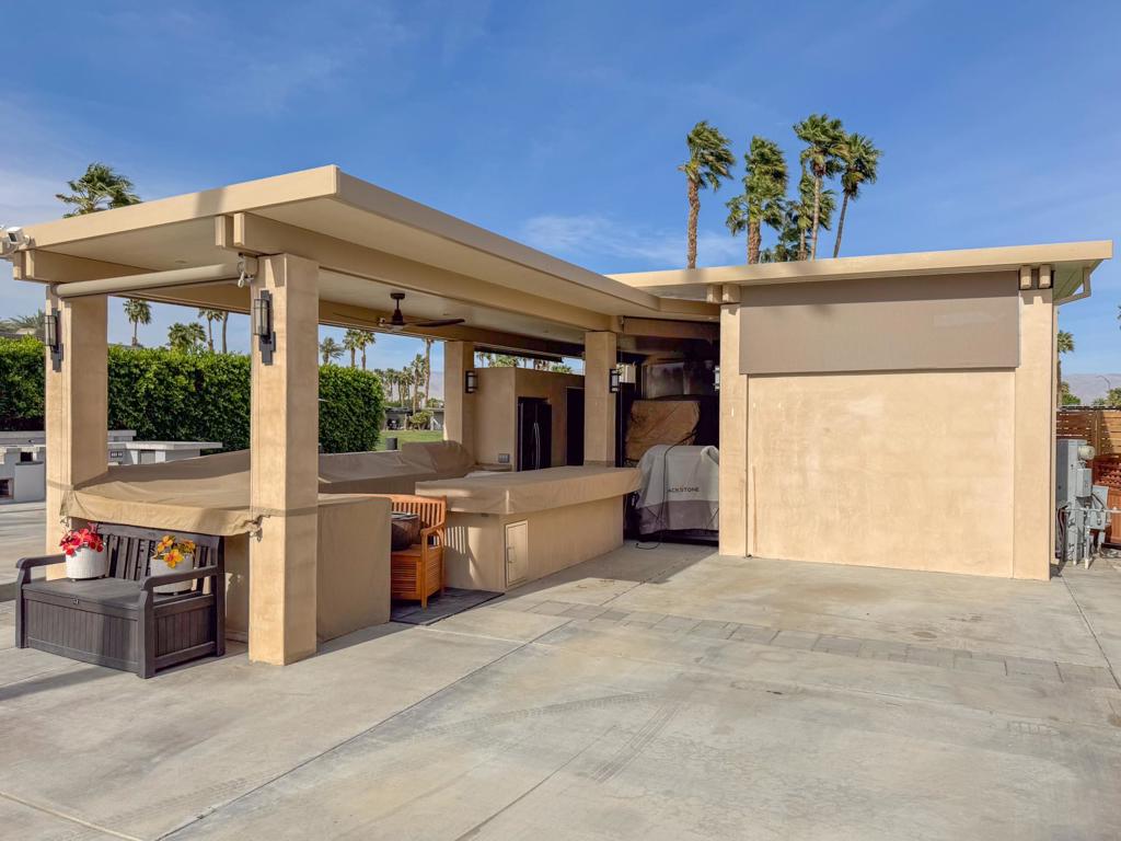 A beautifully designed pergola featuring privacy walls, a built-in entertainment center for relaxing or hosting guests, and a spacious outdoor kitchen with a large kitchen island--perfect for cooking and dining al fresco--anchors this luxurious RV lot, all set against a stunning backdrop of the golf course. The pergola itself is thoughtfully constructed with a solid, L-shaped roof, offering both style and substance, and includes ceiling heaters and fans to ensure comfort. Three privacy walls create a serene and semi-private setting, while electric sunshades provide adjustable shade and privacy throughout the day. The fully equipped kitchen boasts a full-size refrigerator, oven, microwave, and a generous pantry--ideal for extended stays or entertaining. Morning sun warms the space naturally, and the overall atmosphere remains peaceful and quiet, perfect for those seeking a high-end retreat with modern conveniences and beautiful views.‍Outdoor Resort Indio is a Class A only RV resort in Indio, CA.