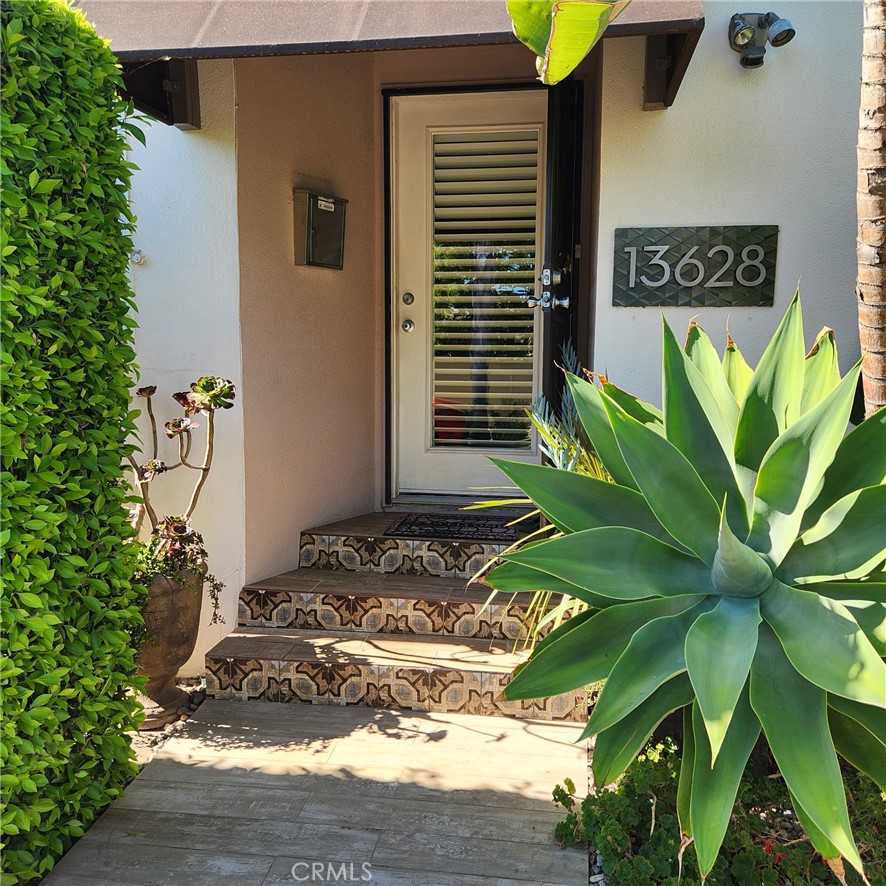 This gorgeous well maintained corner lot in the heart of North Gardena is located in a good neighborhood close to freeways 110, 105 and 405. Proximity and ideally close to shopping malls and markets. This property has multiple upgrades and updates elevating into a comfortable and relaxing home. Featuring remodeled 2 bedrooms, 2 baths, kitchen and dining areas. The attractive front is surrounded by a privacy Ficus hedge which brings a sense of coolness and unique style. Step out of the primary bedroom suite into a lush backyard of fully grown fruit trees and succulents surrounding a
charming covered garden patio which offer privacy and serenity. Outdoor planted areas have low voltage lighting highlighting the plants adding to
sootheness and calm in the evening. Front door and all windows have plantation shutters regulating indoor temperature. The house is equipped
with security system. Other features : -detached spacious and finished 2 car garage; -copperized plumbing and efficient tankless water heater;
-tiled floors throughout the kitchen and bathroom areas; -wood laminate floors on living room and bedrooms; -ceiling fans in every room;
-cooling/heating split system unit; -brand new wall AC/heater bedrooms.