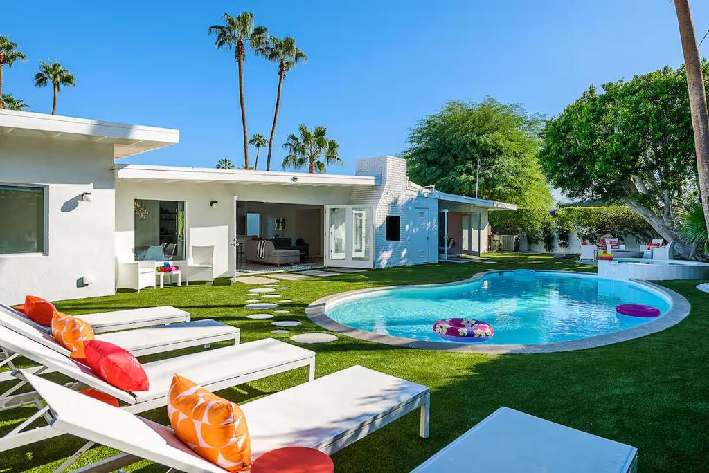 Discover this stunning 4-bedroom, 3-bathroom mid-century Meiselman gem, located in the highly desirable Movie Colony East -- a short walk to Ruth Hardy Park and close to downtown. With 2,342 square feet of meticulously designed living space, this fully furnished residence is ready for you to move in and enjoy. This iconic home boasts lush landscaping, a sparkling pool and spa, and a newly built-in BBQ and bar and fire pit -- perfect for effortless entertaining. With dual en-suite primary bedrooms and two spacious guest rooms, there is enough room for the entire family or friends. Enjoy ultimate relaxation with a private outdoor shower and a personal putting green. Recent improvements include new A/C & furnace (2022), resurfaced roof, kitchen countertops, and turf throughout the property. Take in the breathtaking west-facing views of Mount San Jacinto from your own backyard oasis. A true Palm Springs classic blending timeless design with modern luxury! This home has been an extremely successful vacation rental home and is being offered turn-key furnished.