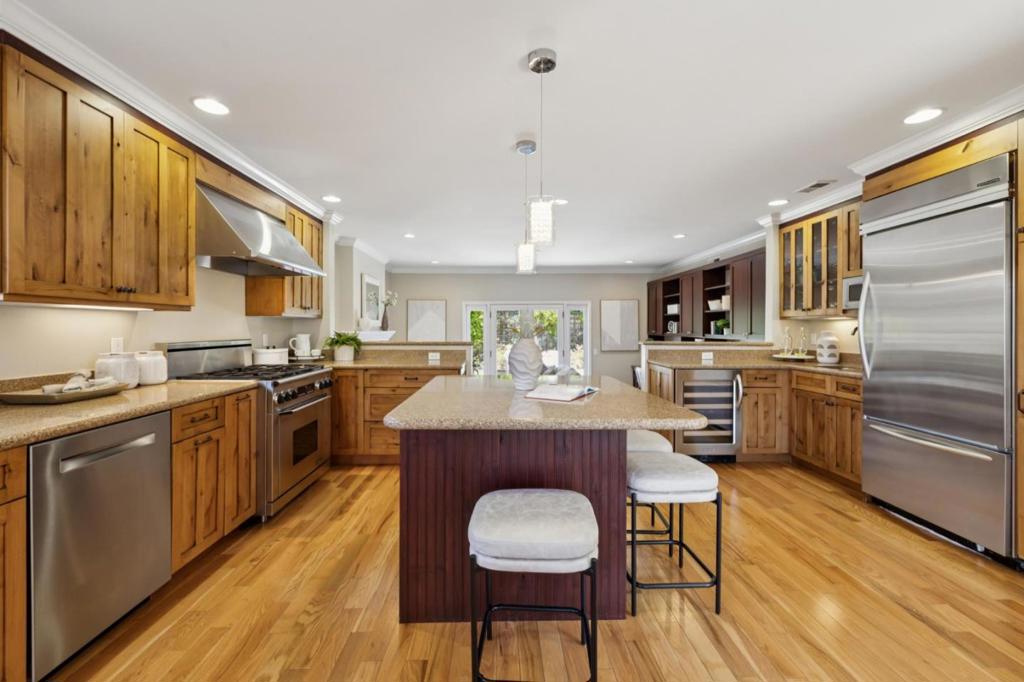 Absolutely stunning rancher with a gigantic and open dream kitchen! Single level beauty with outstanding curb appeal in a cul-de-sac court on a private street with its own park in the center. Extremely sunny and bright with kitchen completely open to living room, family room, and dining. Breathtaking gourmet kitchen with large center island with breakfast nook: granite countertops, ample custom cabinets, high-end SS appliances including Dacor 6 burner gas range and range hood, KitchenAid refrigerator and wine fridge, Bosch dishwasher. Luxurious bathrooms with premium Hansgrohe fixtures, granite countertops and custom cabinets, remodeled shower and tub. Elegant hardwood floor, crown molding, double pane windows and recess lights throughout including inside all the bedrooms. New tankless water heater, gas lines, copper plumbing and sewer pipes. Aesthetic landscaping with paver stones and new lawns. Steps to newly renovated levy and Bay Trail. Conveniently located near award winning Foster City schools, parks, shopping, and with easy access to major highways.
