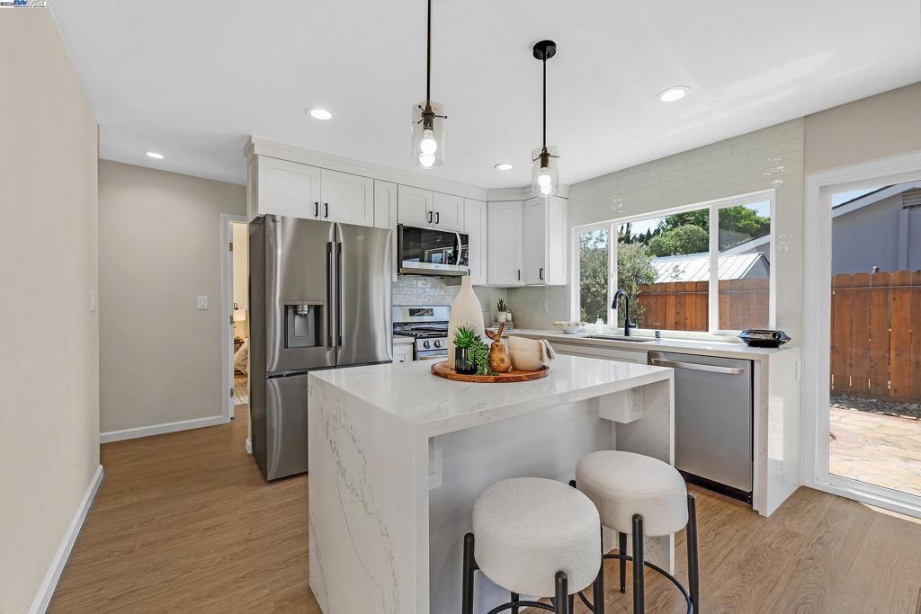 Move-In Ready North Livermore Stunner with Brand-New Finishes! Welcome to this stunning fully remodeled home in North Livermore! Thoughtfully updated throughout, this home features fresh paint, luxury vinyl flooring, and recessed lighting. The open-concept kitchen and dining area boasts a cozy fireplace, an island with a quartz waterfall countertop, and brand-new stainless steel appliances. All windows and sliding glass doors have been replaced, flooding the home with natural light and enhancing the connection to the outdoors. Designed around a charming courtyard patio, each bedroom enjoys its own sliding door access and serene views. Both bathrooms have been beautifully updated with modern finishes. Additional upgrades include a brand-new roof, new HVAC system with updated ducting, and owned solar for energy efficiency. Move-in ready with a perfect blend of style, comfort, and functionality — a true North Livermore gem! Exterior photos coming soon!