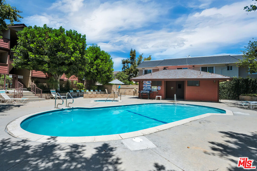 Nestled in a well-maintained gated community, this top-level home is tucked away in the back of the community, offering privacy, peace and comfort. The spacious living room features a cozy fireplace and direct access to a private balcony that overlooks the pool and is ideal for morning coffee or evening relaxation. Step into the dining area and kitchen, complete with plenty of storage and counter space. It also has recently updated appliances and an HVAC unit. You'll also find two generously sized bedrooms, each with its own en-suite bathroom. Additional highlights include in-unit laundry, semi-private garage with two tandem parking spaces, additional storage closet, well-kept community grounds, a sparkling pool and spa, and ample guest parking. Conveniently located near shopping, dining, parks, hiking trails, and easy 118 freeway accessthis home is a true gem in the San Fernando Valley!