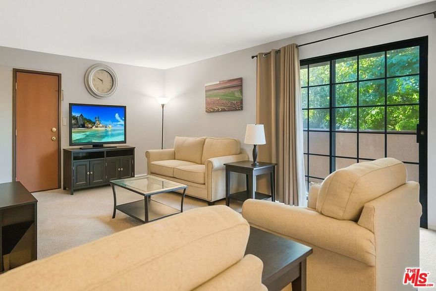 Nestled in a well-maintained gated community, this top-level home is tucked away in the back of the community, offering privacy, peace and comfort. The spacious living room features a cozy fireplace and direct access to a private balcony that overlooks the pool and is ideal for morning coffee or evening relaxation. Step into the dining area and kitchen, complete with plenty of storage and counter space. It also has recently updated appliances and an HVAC unit. You'll also find two generously sized bedrooms, each with its own en-suite bathroom.  Additional highlights include in-unit laundry, semi-private garage with two tandem parking spaces, additional storage closet, well-kept community grounds, a sparkling pool and spa, and ample guest parking.  Conveniently located near shopping, dining, parks, hiking trails, and easy 118 freeway accessthis home is a true gem in the San Fernando Valley!