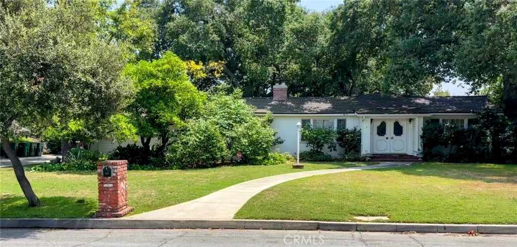 One of the most beautiful, large properties in the sought after Baldwin Stocker area of Arcadia. The park-like grounds, spanning over 1/2 acre has been the site of many events over the years from family celebrations to garden parties benefiting community organizations. This beloved three bedroom, two bath, 1,834 square foot home has been the backdrop for many wonderful memories for four generations.
The double-doored entry welcomes you into a sunlit living room boasting a large picture window with views of the mountains and a coveted Batchelder Tile fireplace. Off the living room a cozy library/den offers a quiet space for reading or working from home. The living room opens to the the formal dining room with french doors leading to the beautiful tree shaded patio - the ultimate in California entertaining.
Off the dining room is the updated kitchen featuring quartz countertops. Relax over coffee in the sunlit breakfast nook overlooking the beautiful backyard. The bedrooms are conveniently located along the west side of the home.
The crowning glory of the home is the park like backyard with meandering paths for discovering many fruit trees a raised garden, quiet places for introspection and a charming historical guest cottage that was relocated from the US Army Balloon School in Arcadia in the 1920's.
Freshly painted with updated kitchen and bathrooms this wonderful home is ready for it's new owners to move in and bring it into its next chapter.