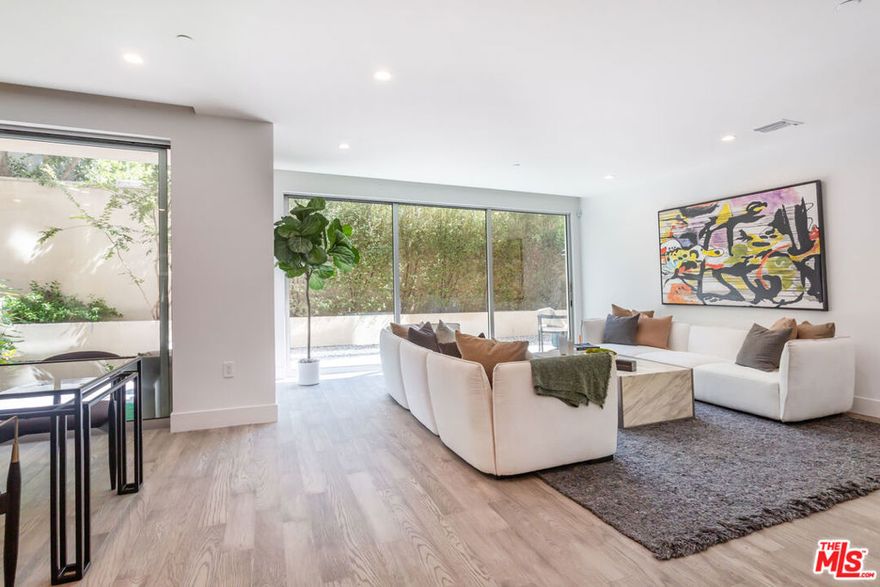 Discover a rare corner 2-story townhome offering 2,463 SF of thoughtfully designed living space and a 543 SF expansive patio. This home features 2 bedrooms, 2 full baths, 2 powder rooms, a dedicated laundry room, and a versatile 445 SF flex space on the lower level. An oversized private 2-car garage with direct home access provides unmatched convenience. The main level boasts an expansive kitchen with island, crafted with Snaidero Italian cabinetry and premium Sub-Zero/Wolf appliances. The open-concept layout connects seamlessly to the dining and living areas, while a formal entry and spacious outdoor patio create a lifestyle beyond the standard condominium. Refined finishes include Caesarstone countertops, Italian Gessi plumbing fixtures, and Hydro Systems soaking tubs. Only two townhomes remain at The Ainsley, a boutique community nestled on a highly walkable, tree-lined street just steps from the best of Melrose. Residents enjoy exclusive amenities including concierge services, a private lounge, fitness center, yoga and training rooms, and more.