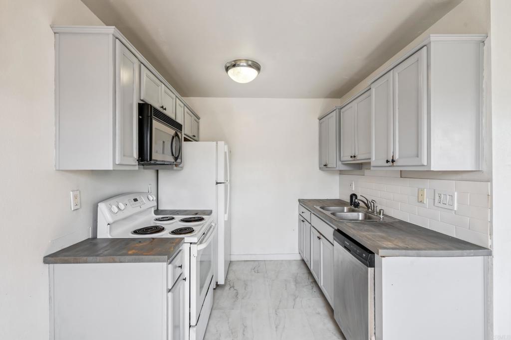 One of the most affordable homes in San Diego County... your two bedroom, one bath condo awaits! Complex is VA approved! A potential starter home or investment property, this unit comes equipped with wall A/C, electric range, dishwasher, microwave, and refrigerator. Updated flooring throughout, fresh paint, subway backsplash tiling in the kitchen, mirrored closets. Updated windows, baseboards, bathroom vanity and toilet. Unit is inside a fully gated community, centrally located with nearby public transit. Equipped with a low HOA that includes a shared quart yard, grill, laundry facility, and one reserved parking spot. Plenty of street parking for guests, and walkable location to restaurants and shopping areas. Close freeway access makes this unit perfectly situated for those wishing to explore all of what San Diego has to offer!