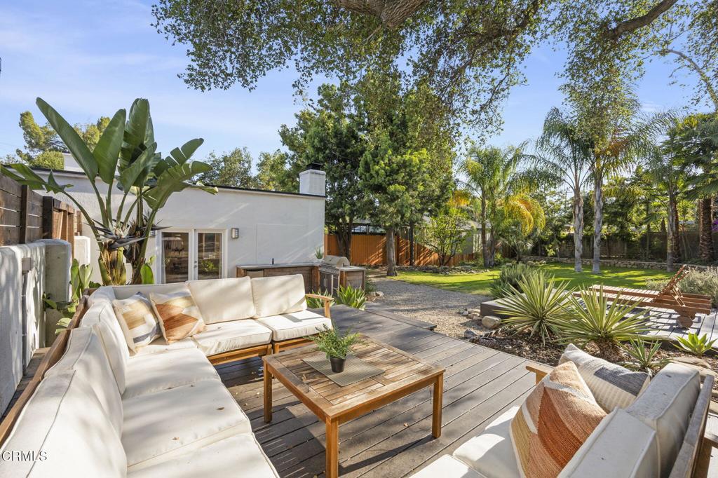 With an enviable location at the upper end of Canada St just blocks from downtown Ojai, this one of a kind 4 bedroom 4 bath Art Deco home features curved lines with a Mid Century feel. Upon entering you are greeted with ample windows allowing natural light to filter in. A gourmet kitchen opens up to the generous living room and dining room area equipped with a cozy fireplace and french doors leading out to the spacious backyard. Upstairs you will find a separate guest wing with its own private rooftop patio to enjoy the mountain views. Situated on .38 acres with decks for lounging, fruit trees, a fountain and mature landscaping. Additional features include a detached 2 car garage and an outdoor BBQ area. A true retreat in the heart of Ojai!