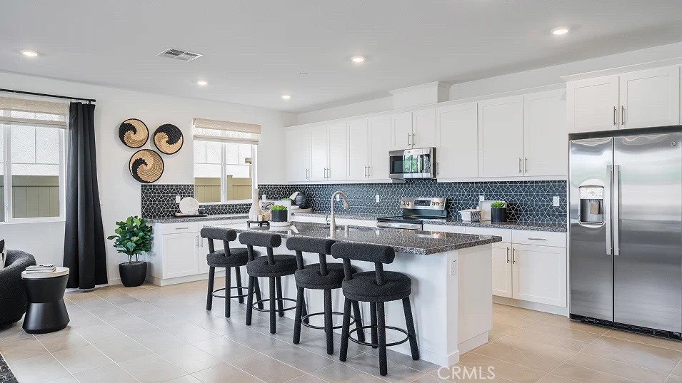 NEW CONSTRUCTION! This new three-bedroom home offers convenient single-story living. Two bedrooms are located off the entry, leading to a spacious open-concept floorplan where the kitchen, dining room and Great Room meet. The luxurious owner’s suite is nestled into a private rear corner, complete with a full bathroom and walk-in closet.
Armonia is a new series offering brand-new single family homes for sale now selling in the Legado masterplan in Menifee, CA. The community offers an amenity-rich lifestyle with access to a modern clubhouse, sport courts, multiuse trails and much more. Nature lovers will enjoy ample outdoor recreation on nearby Lake Menifee and at Menifee Lakes Park or Paloma Valley Park. The Promenade at Menifee Valley is a local shopping center with an array of shopping, dining and entertainment options.