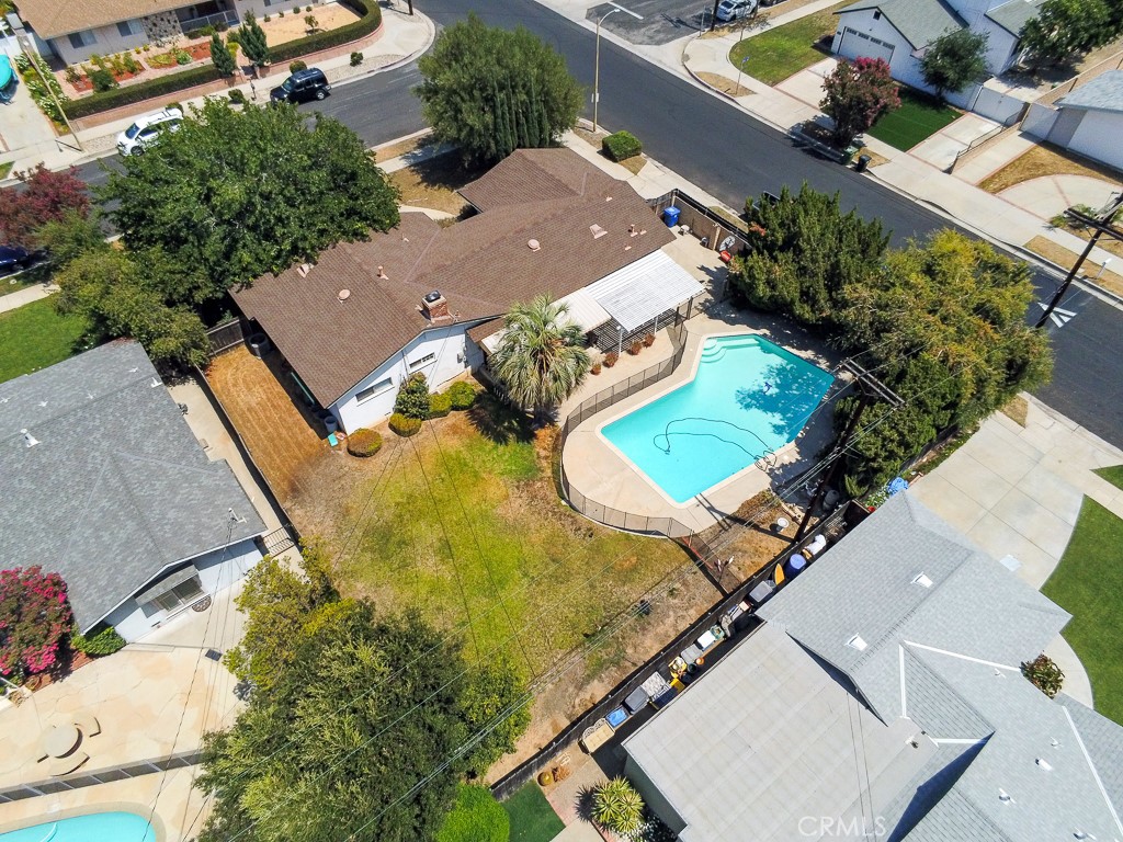 *** Charming Northridge Home with Pool & ADU Potential ***
Welcome to this lovingly maintained residence, cherished by the same family for the past 47 years. Nestled on a generous 10,834 sq. ft. corner lot in a sought-after Northridge neighborhood, this home offers timeless character and endless possibilities.
Step inside to a flowing 1,544 sq. ft. floor plan highlighted by an inviting mix of bamboo, hardwood, and plush carpet flooring. The spacious living room is filled with natural light from custom French doors and features a striking floor-to-ceiling brick fireplace with raised hearth—perfect for gatherings.
The kitchen provides ample cabinetry, generous counter space, and a lighted ceiling fan, seamlessly connecting to the dining area. A cozy den/office and a conveniently located laundry room with backyard access add to the home’s functionality.
There are 3 comfortable bedrooms, each with ceiling fans, plus 2¼ bathrooms—including a well-placed pool bath for easy outdoor entertaining.
Upgrades include dual-pane windows, copper plumbing, and a 2-year-old central air & heat system, ensuring efficiency and year-round comfort.
The private backyard is designed for relaxation and fun, featuring a covered patio, lush lawn, privacy fencing, and a sparkling re-plastered pool. With a side entrance, the attached 2-car garage is a great candidate for a JR. ADU conversion, and the expansive yard offers space for an additional ADU.
Located near award-winning schools—including Granada Hills Charter High School—as well as shopping, dining, and easy freeway access (118 & 405), this home combines convenience, comfort, and potential.
With its solid foundation and “great bones,” this is your opportunity to add your personal touch and create the oasis you’ve been dreaming of.
Call today to schedule your private showing!