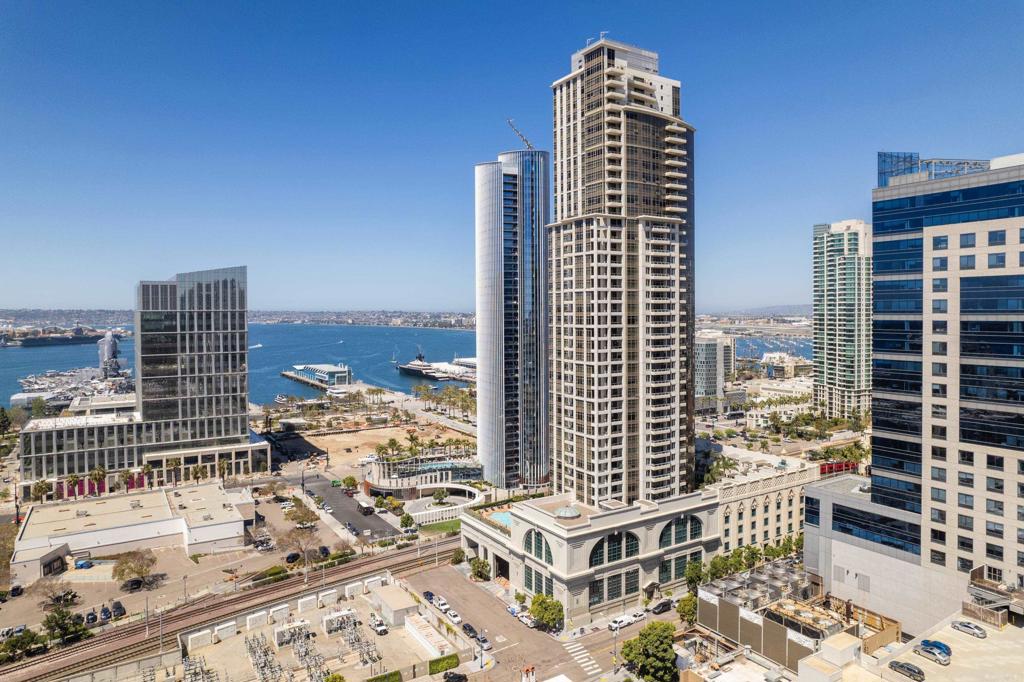 America's Finest City has never looked better from this stunning 19th floor Electra with picturesque views from every direction. Contemporary sophistication awaits you in this highly desired (‘04 stack location) luxury condo featuring 2 bedrooms, 2 bathrooms & 1468 square feet of living space with elite ocean, San Diego Bay, Coronado & twinkling cityscape views. The equally impressive interior boasts a custom designed kitchen with natural stone countertops & waterfall edge, Bosch appliances, designer dimmable pendant lighting, high quality hardwood flooring, smart home features, 2 beautiful view balconies, full sized LG stacked washer/dryer, dual zoned HVAC & 2 parking spaces next to an electric charging station. Electras top-tier resident amenities include 24 hour concierge & top notch security. Luxuriate in the resort-style pool, spa, steam room, fitness center & romantic outdoor fireplace. A short walk to Waterfront Park, Seaport Village, historic train station, Little Italy, The Radys Shell, Petco Park & fabulous restaurants & shopping.