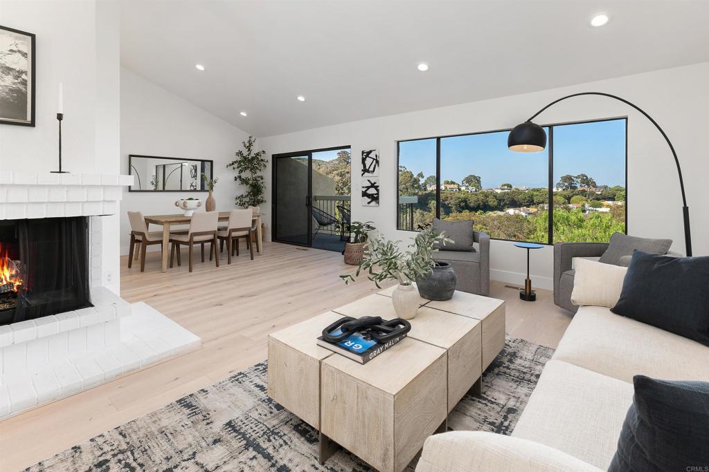 If you're looking for a deal, this is it! The last model match sold for $1,595,000!! There are absolutely AMAZING VIEWS in this beautifully updated two bedroom, two-and-a-half-bathroom home at the end of a cul-de-sac in the 24-hour guard gated Windmere community. Open beam cathedral ceilings greet you in the entry with brand new wide plank french oak style hardwood flooring and breathtaking sit-down views of the La Jolla hillside from the living room, dining area and kitchen. The kitchen, living and dining areas are upstairs to take in the views and all rooms have newly installed hardwood floors. Downstairs are two generously sized bedrooms, both en-suite with brand new tile in both baths. The primary bedroom has a spacious walk-in closet. There's also plenty of storage in the garage as well! It's a short two minute walk down to the clubhouse from your home to relax at one of the pools, play tennis, pickleball, racquetball, basketball or relax at your private park with a lake. Windemere offers unparalleled amenities you won't find anywhere else along the San Diego Coastline - there's even RV parking! This is a true "lock and leave" home. An absolutely perfect second home or use it as your primary. The lowest priced home currently available in Windemere by $475,000!! Hurry before it's gone!